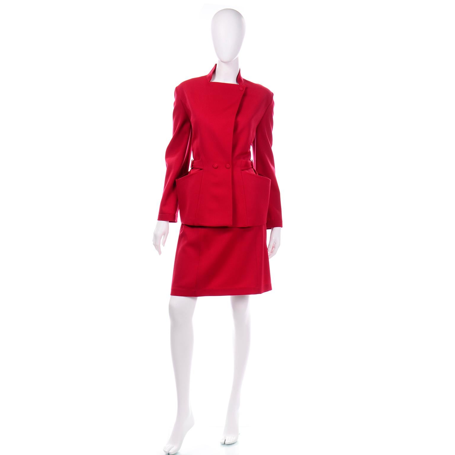 This is a stunning worsted wool red skirt suit designed by Thierry Mugler in the late 1980's or early 1990's. The jacket is very unique and fitted at the waist, in Mugler's signature style. There is an adjustable belt on each side of the waist to