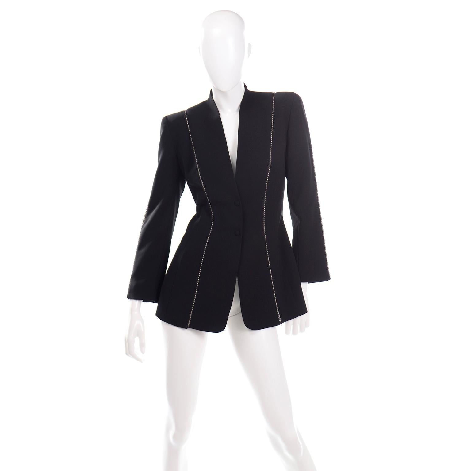 This vintage Thierry Mugler black structured blazer has a very unique metal ball chain detail along the front, back and sleeves. The ball chain is covered by sheer black silk. This style of blazer is similar to a lot of Thierry Mugler's blazers,