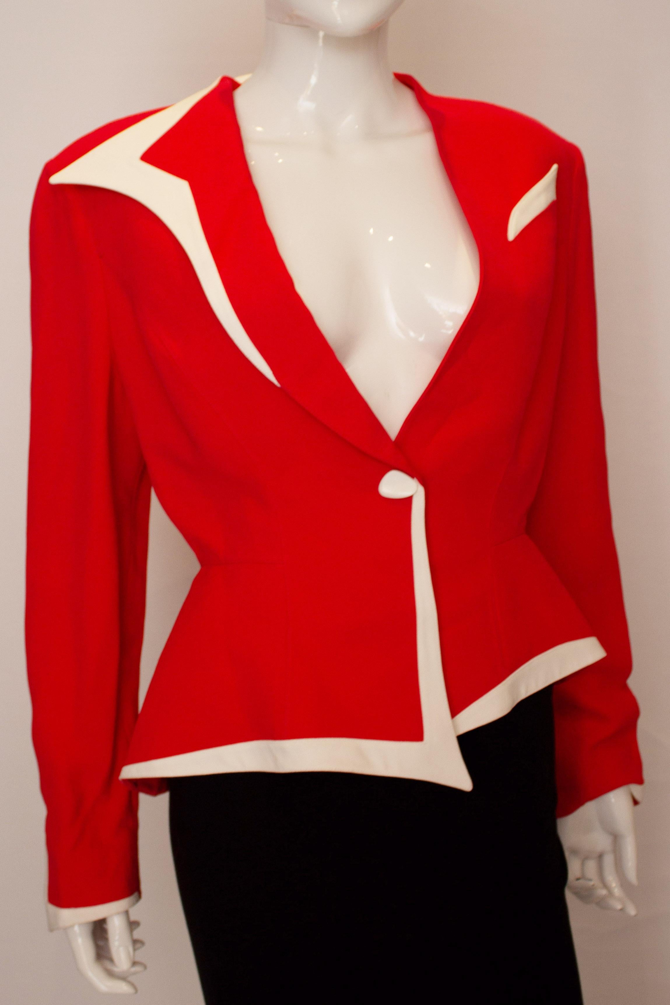 A chic vintage jacket by Thierry Mugler. The jacket is red with white trim on the cuffs and hem. It has an open neckline and will fit a bust up top 40''.