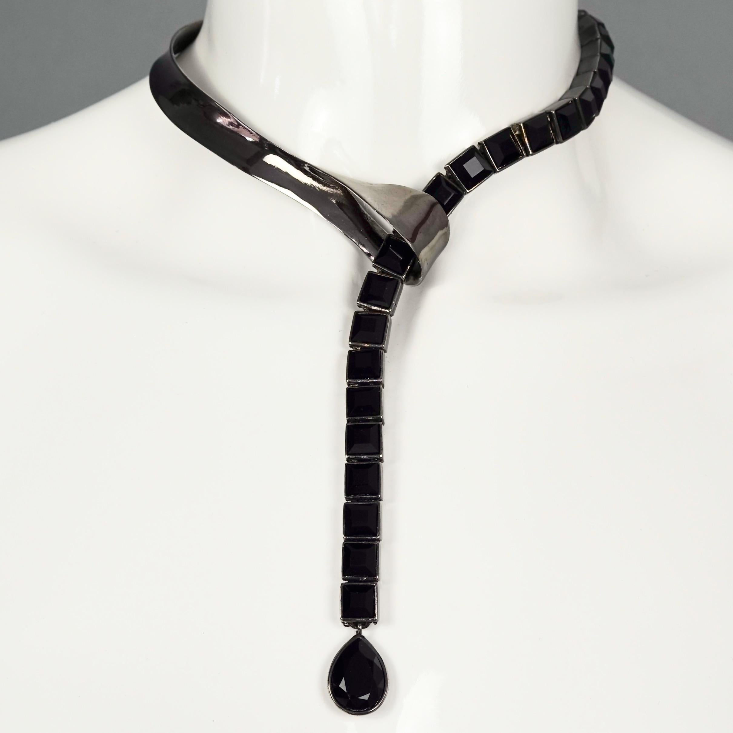 Vintage THIERRY MUGLER Space Age Black Chrome Lariat Necklace

Measurements:
One size fits most.

Features:
- 100% Authentic Thierry Mugler.
- Black chrome rigid metal on the side.
- Articulated black stones on the other side to be inserted into the