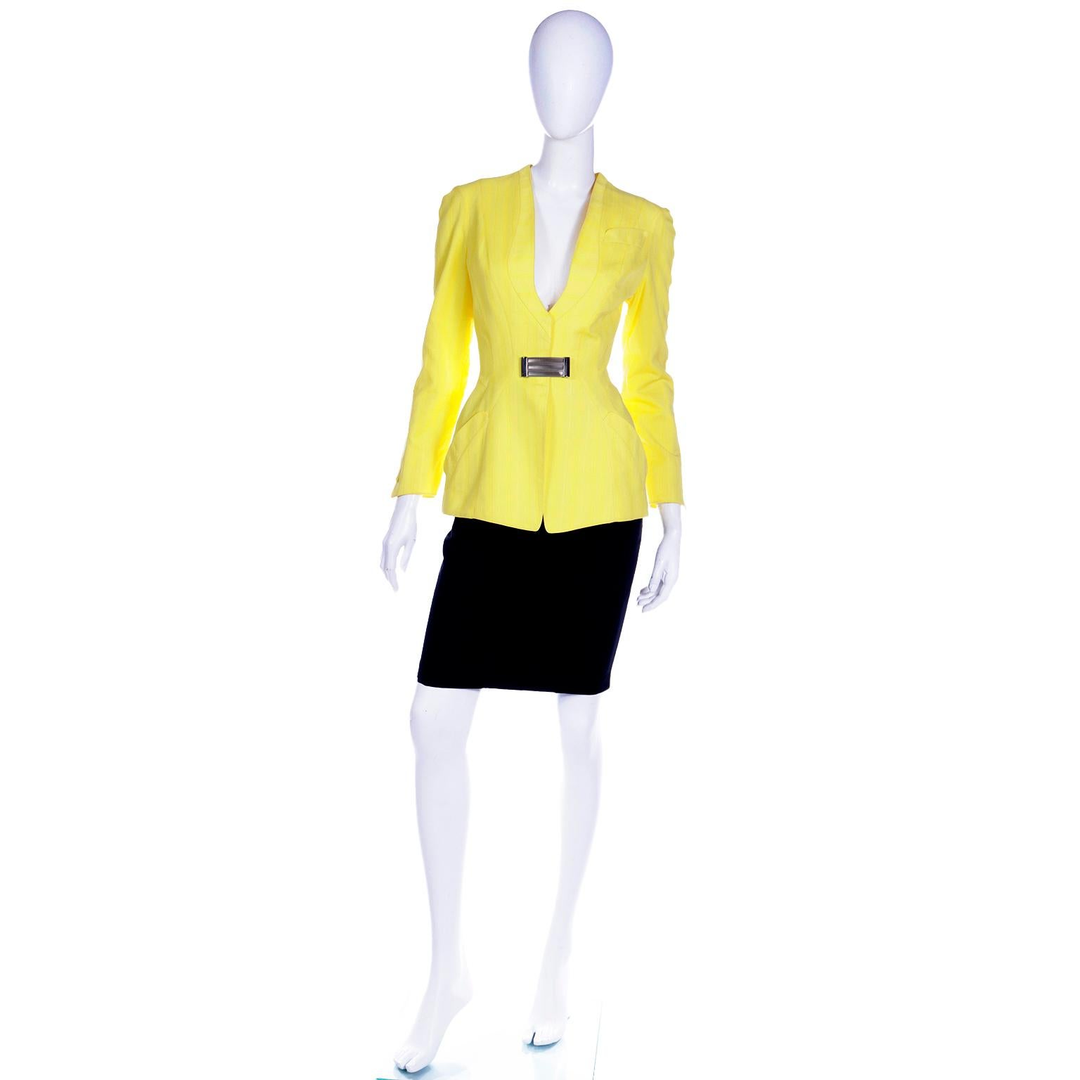 We love vintage Thierry Mugler and this show stopping 2 piece skirt suit is so stunning! The ensemble includes a slim tonal striped black cotton pencil skirt and a contrasting tonal striped yellow cotton jacket with a plunging neckline. The skirt