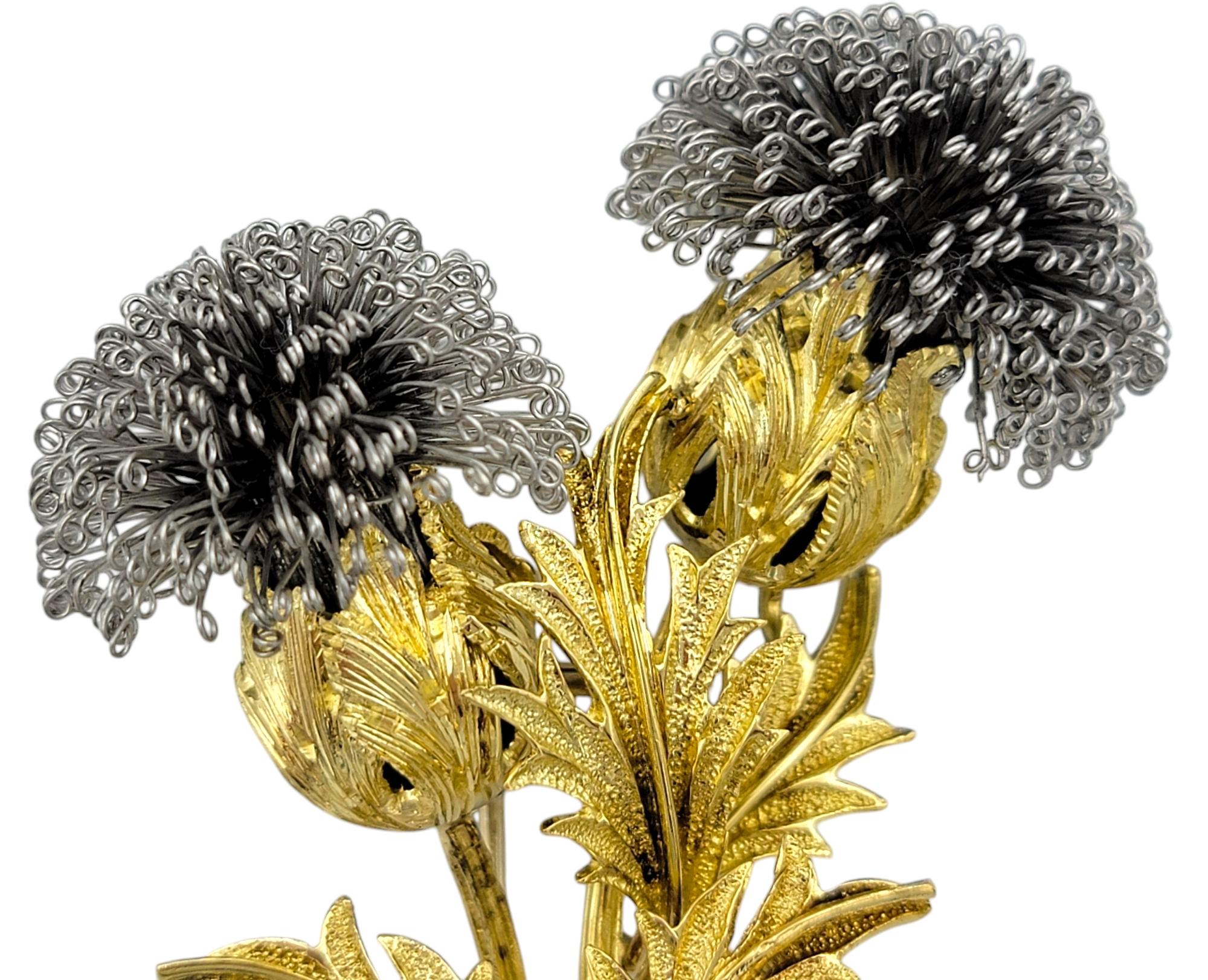 Celebrate vintage elegance with this exquisite thistle brooch, crafted in 18 karat yellow and white gold. The intricate design captures the natural beauty of the thistle, with delicately textured gold leaves and striking white gold accents that add