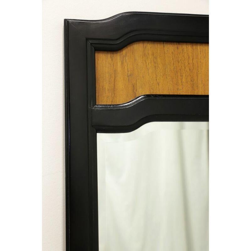 An Asian influenced wall mirror by Thomasville, from their Embassy Collection. Beveled mirrored glass with pecan and black lacquer frame. Made in Thomasville, North Carolina, USA, in the late 20th Century. 

Style #: 19111-220

Measures: 29.75w 1d