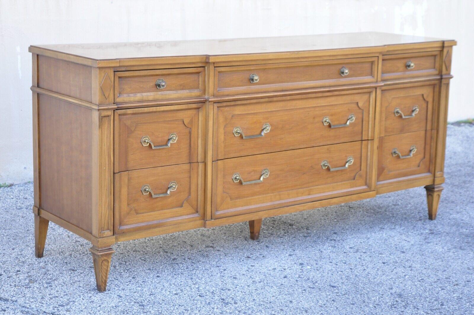 Vintage Thomasville Italian Provincial style walnut 9 drawer triple dresser. Item features beautiful wood grain, original stamp, 9 dovetailed drawers, quality American craftsmanship, great style and form. Circa mid to late 20th century.
