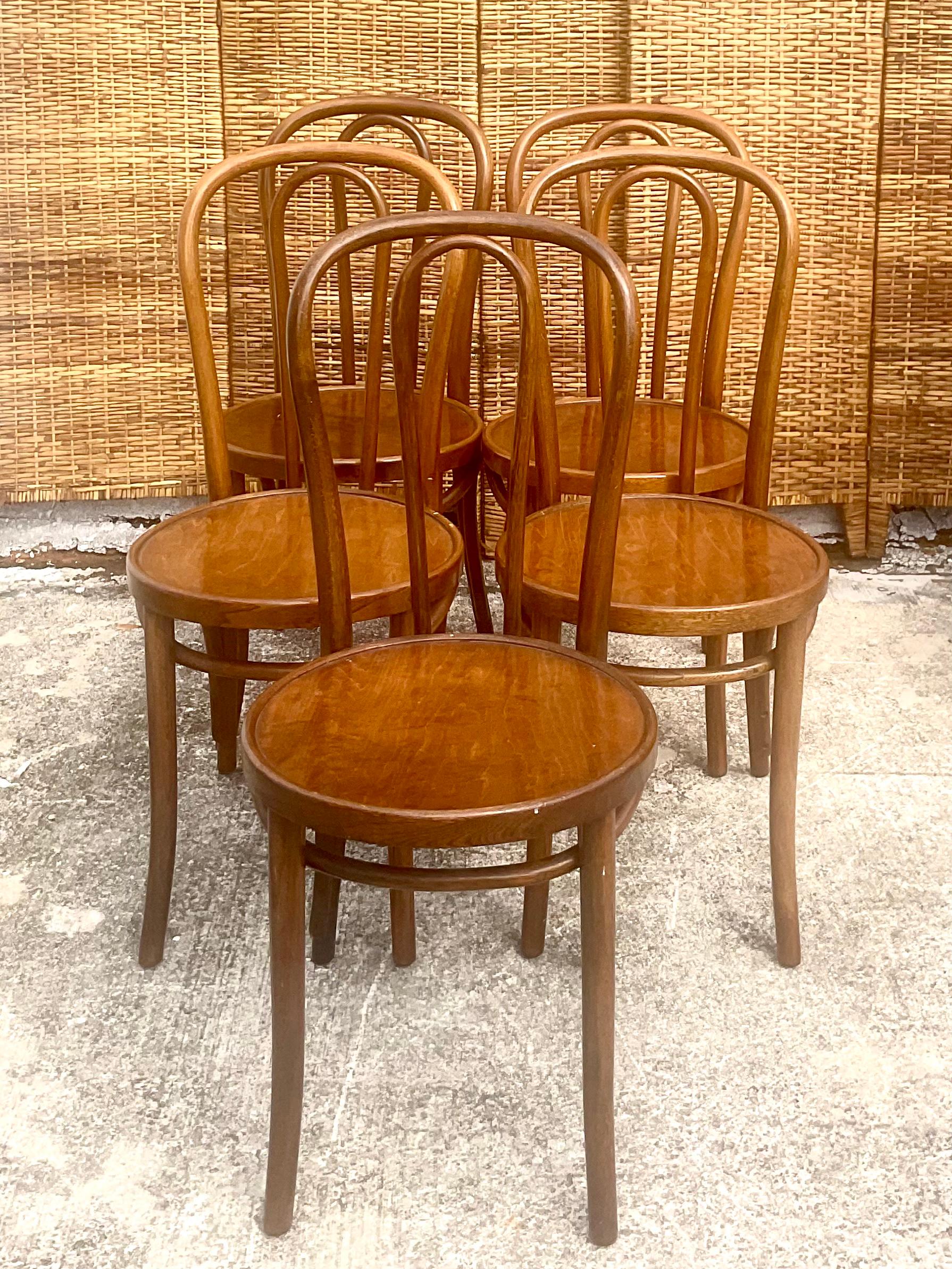Fantastic set of 5 Thonet dining chairs. Beautiful bent wood design with wooden seats. In great shape with original tags on four of the five chairs. Acquired from a Palm Beach estate.