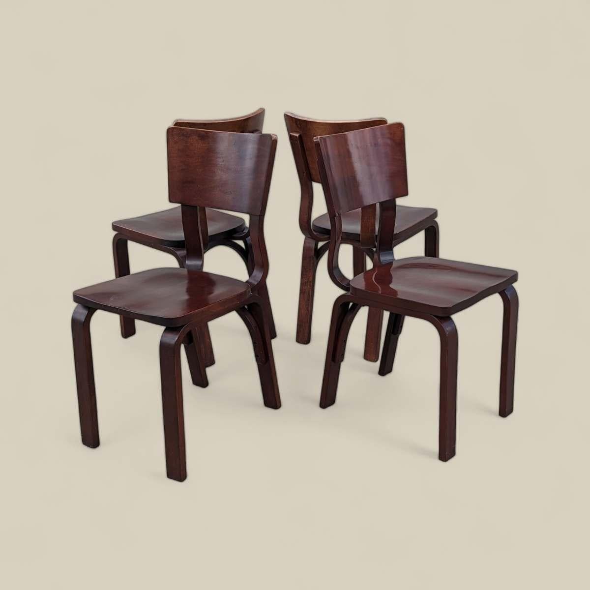 Vintage Thonet Bentwood Dining Chairs - Set of 4 

Late-20th century bentwood dining chairs by Thonet, the renowned maker of bent beechwood furniture. Featuring Thonet's signature curved frames handcrafted from solid beechwood with a rich