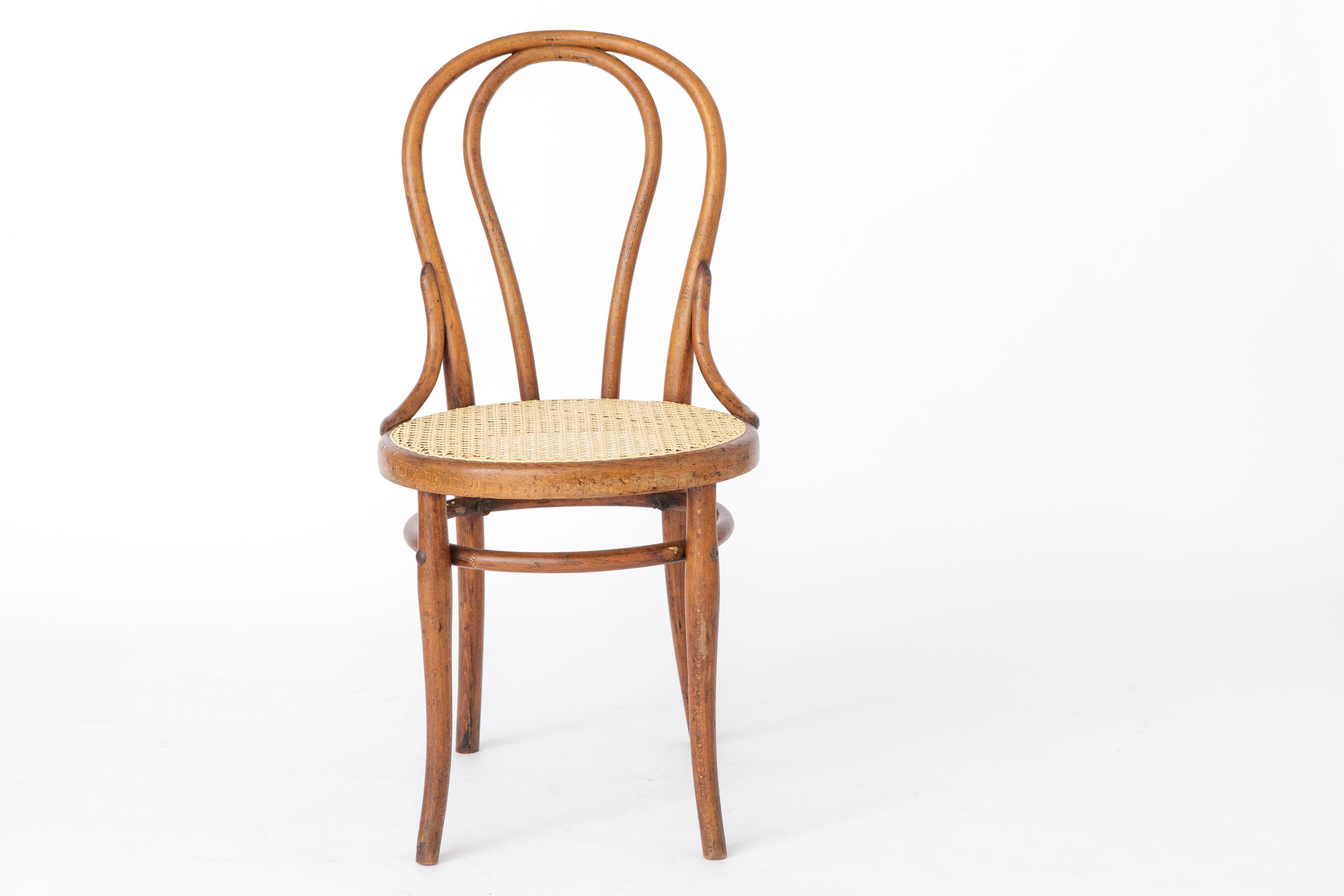 Thonet bentwood chair, Model No. 18 from 1890. 
Production period: approx. 1920s-1940s. 

Stable dyed beech wood frame. 
Some distinct sings of use. See pictures. 
Sturdy frame. Renewed Viennese hand cane weaving. 
Thonet stamp under the seat.