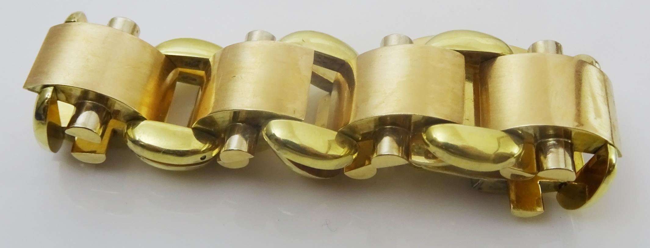 
 
A Unique Vintage Link Bracelet probably from the 1940's, It is manufactured in 14 karat two color gold (Yellow andPink). There is a hallmark but it is illegible, and it has been acid tested for 14 karat. 
The Pink Gold Links are Matte and the