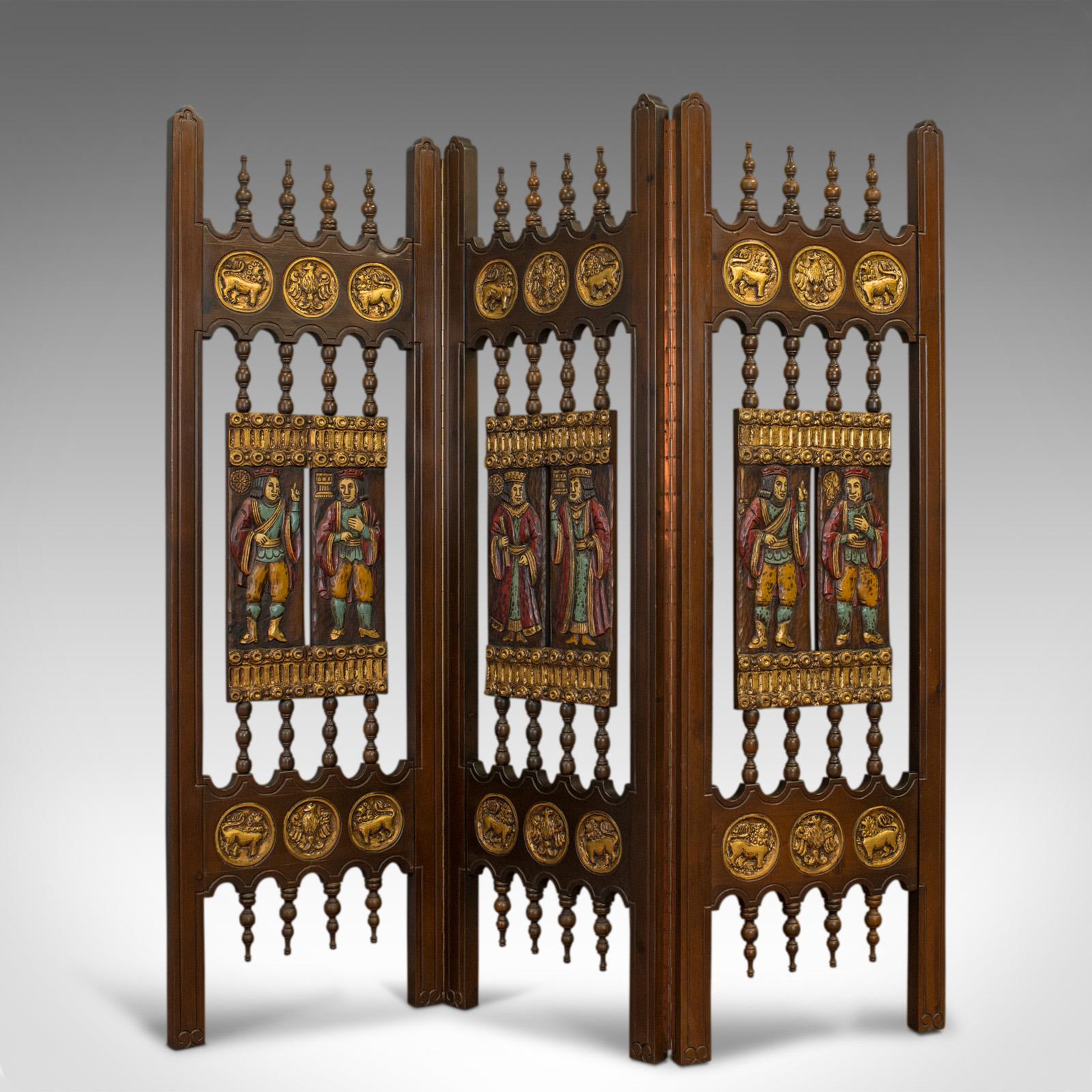 This is a vintage three-fold screen. A painted, French, folding room-divider in the medieval taste, crafted in the mid-20th century.

Fine ornate carved detail, painted panels and gilt highlights
In superb original condition with a desirable aged