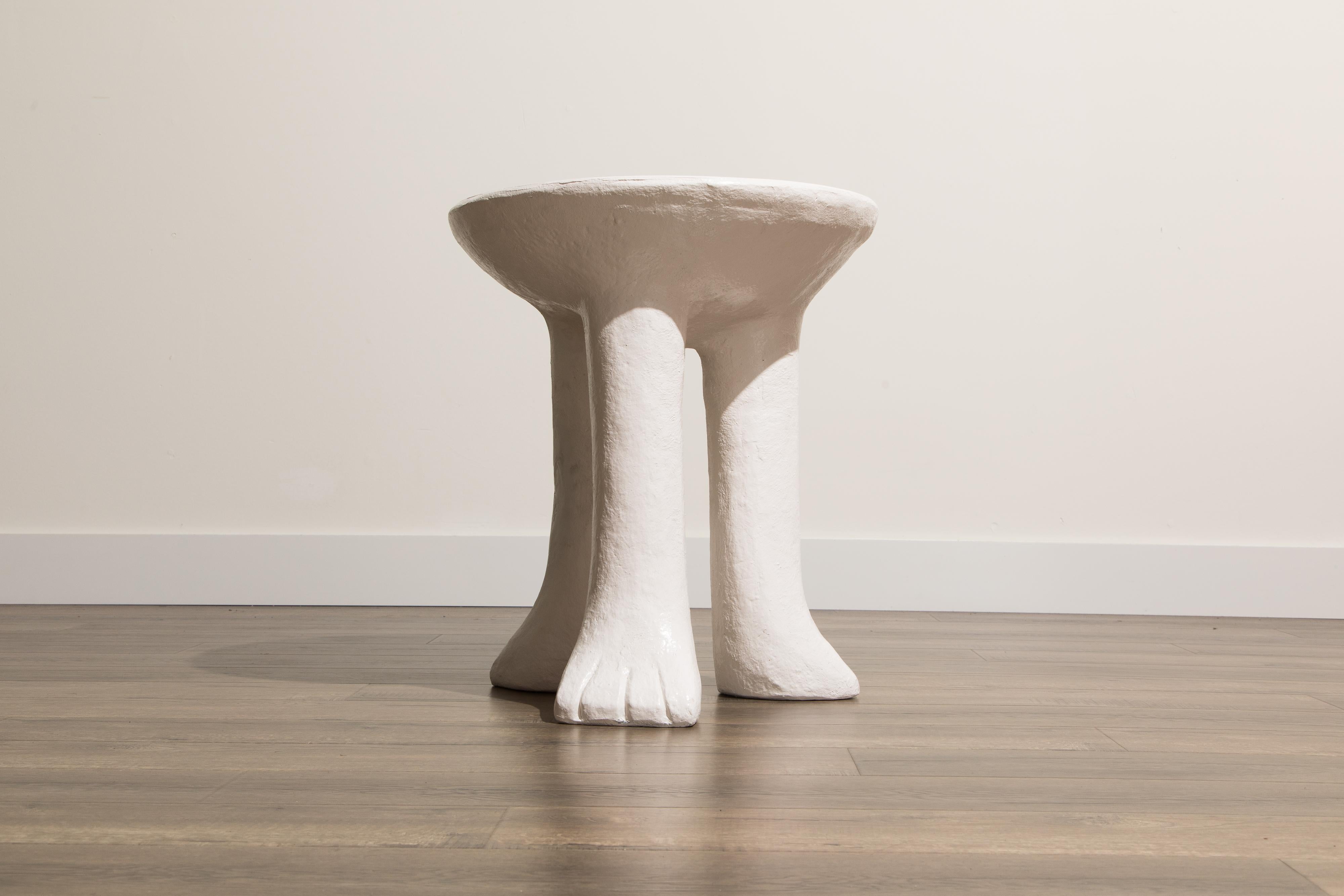 This attractive three-legged side table in the style of John Dickinson's 