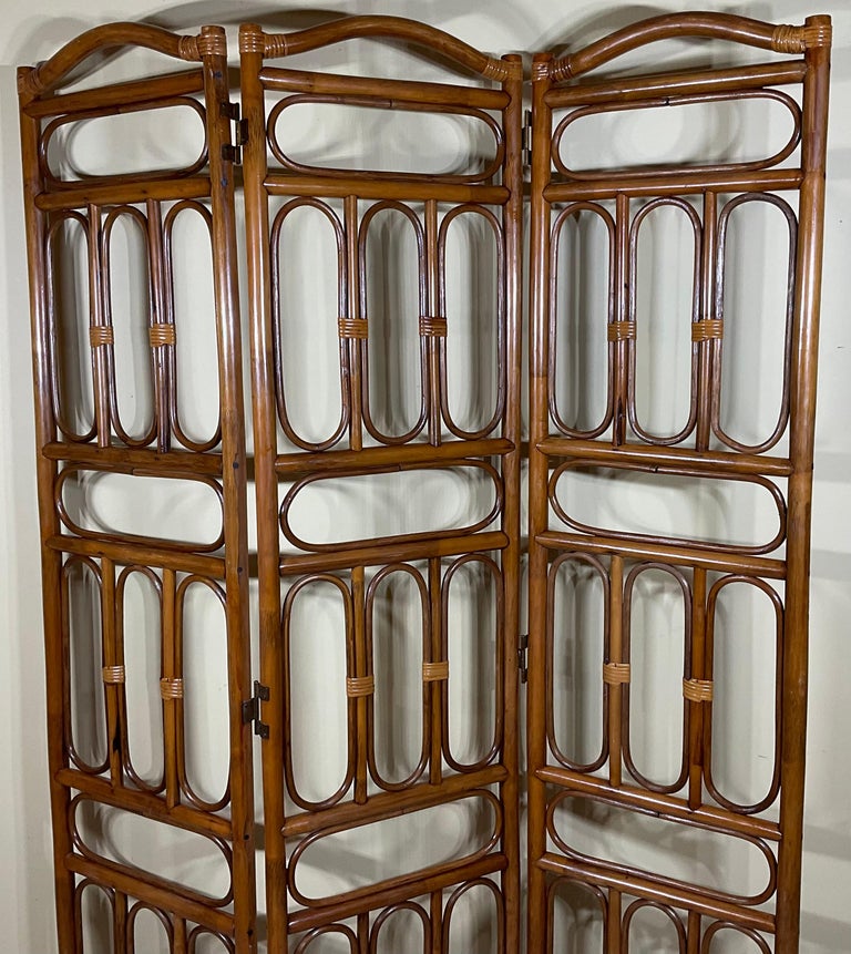 Three panel arched top bamboo screen. Each panel is 17.25 wide and 74” high. Screen was professionally cleaned reinforced, and new wood stain Coat.
 