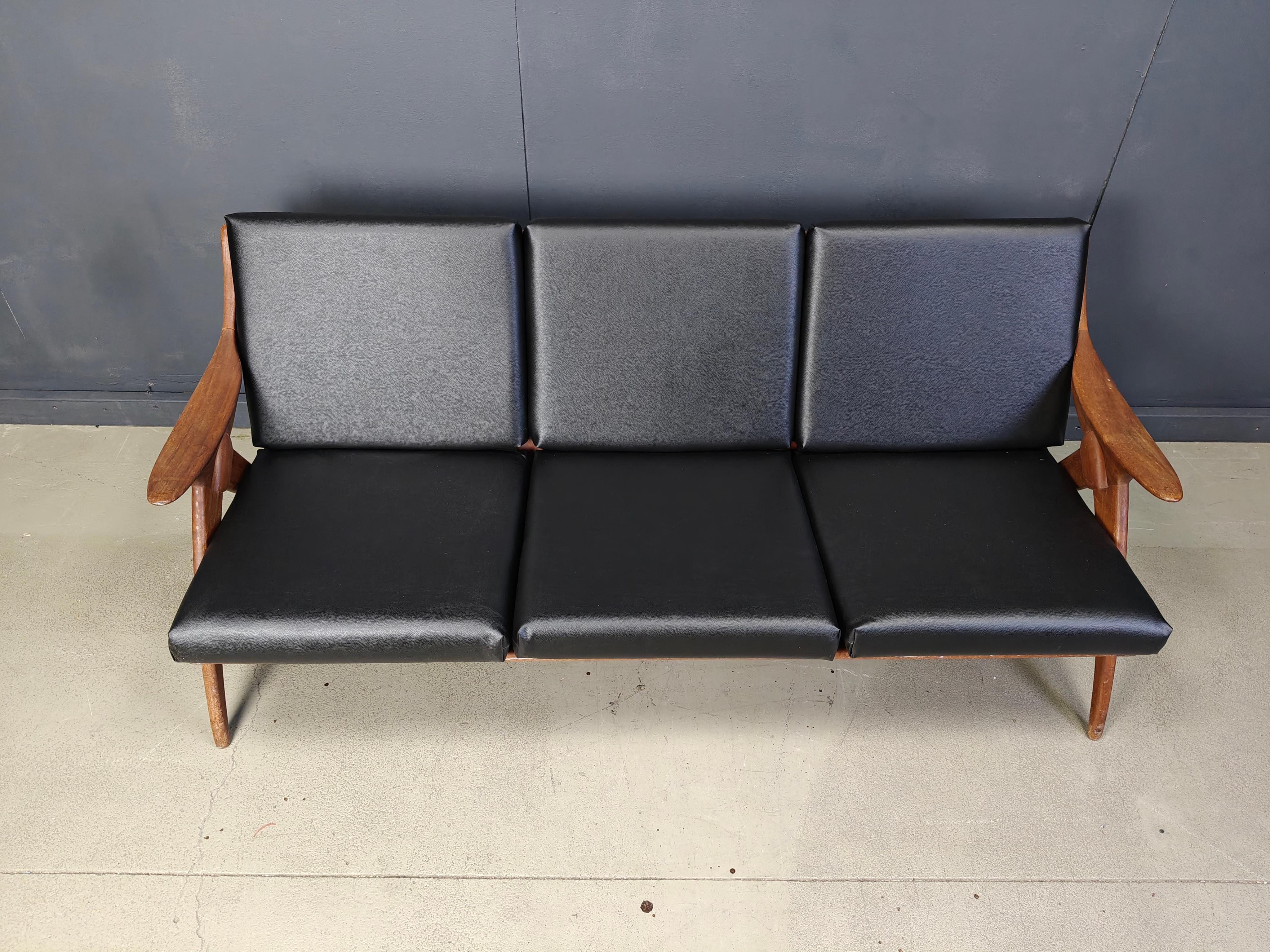 Beautiful mid century three seater sofa with a nicely organic designed teak wooden frame and newly upholstered faux leather cushions.

This model is called 'de Knoop'.

Eye catching dutch design.

1960s - Netherlands

Dimensions
Height: 80cm
Width:
