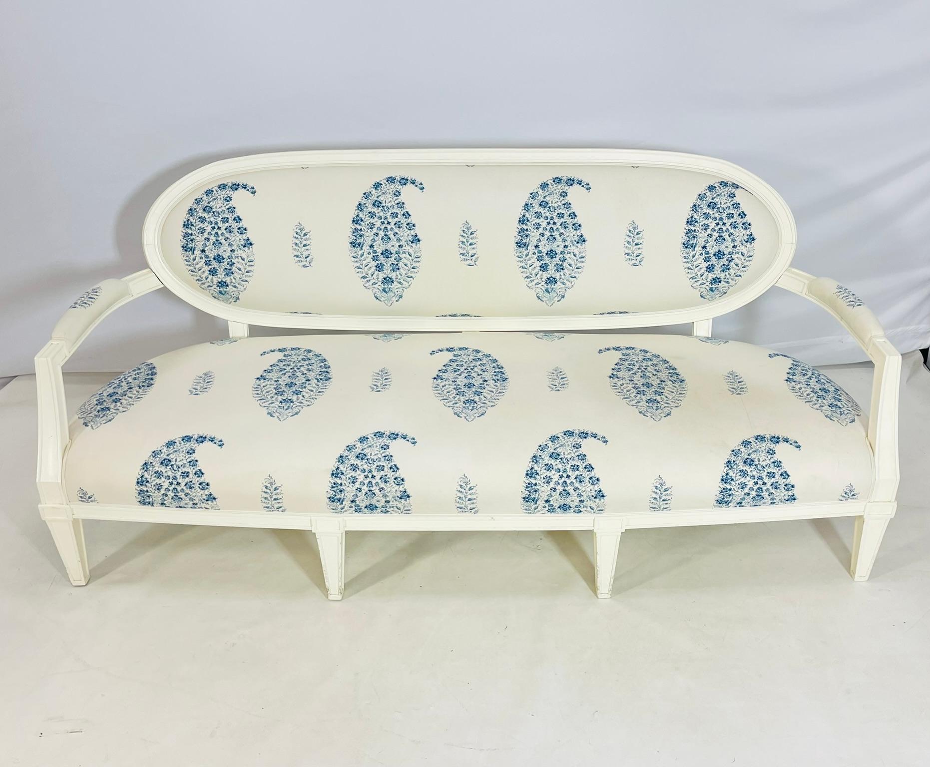 Vintage three seater sofa designed and manufactured in the United States by Brunschwig & Fils.

The piece has a beautiful white wooden frame and upholstered in a white and blue fabric.

The sofa retains the manufacturers label to the