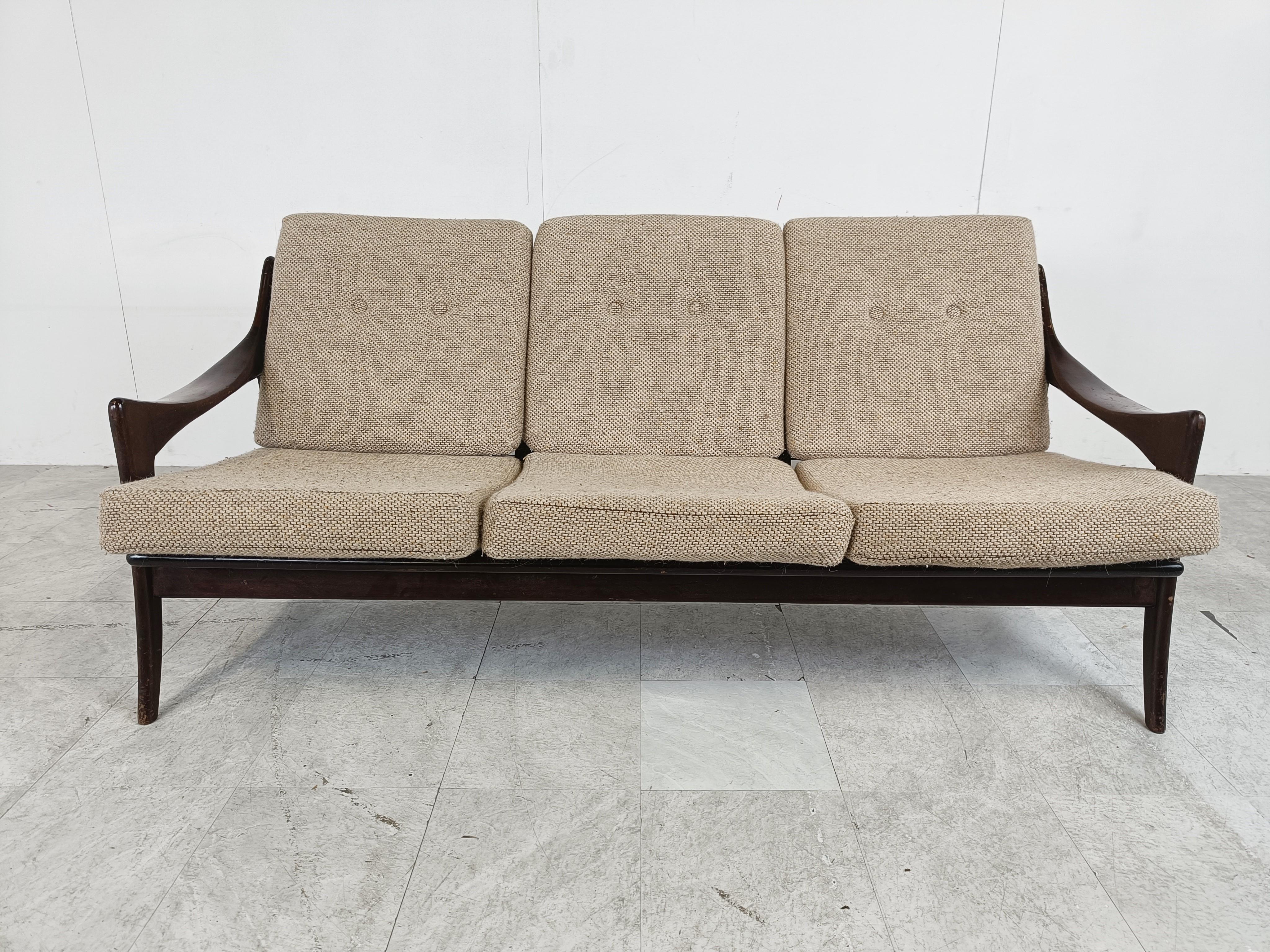 Beautiful midcentury three seater sofa with a nicely organic designed teak wooden frame and grey fabric cushions.

Eye catching dutch design.

The frame has some user traces at the back and on the armrests but the design still makes it stand