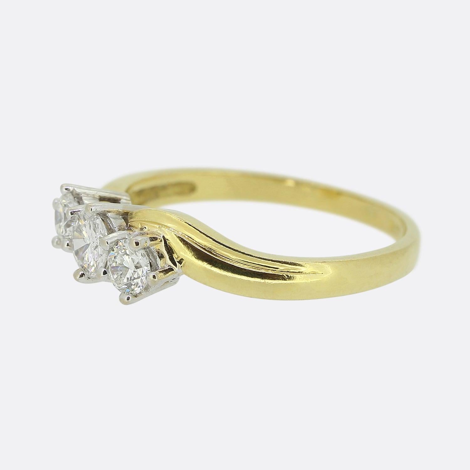 Here we have a vintage diamond three-stone ring. The band of this piece has been crafted from 18ct yellow gold in a swirling style and acts as the backdrop and host to a trio of natural round brilliant cut diamonds. 

Condition: Used (Very