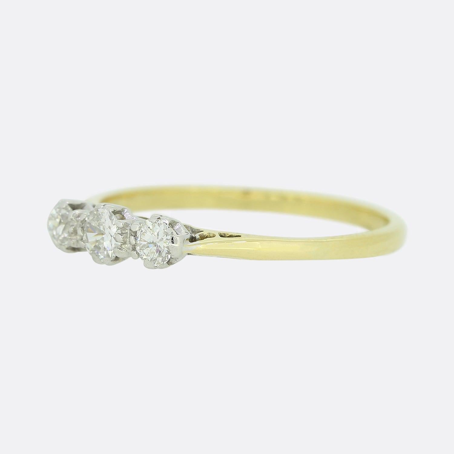 This is an 18ct yellow gold three-stone diamond ring. This vintage ring plays host to 3 round brilliant cut diamonds in a white gold setting to help bring out their sparkle.

Condition: Used (Very Good)
Weight: 2.0 grams
Size:P
Total Diamond Carat