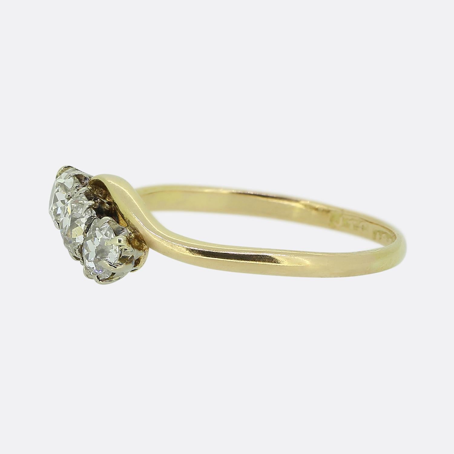 Here we have a vintage three-stone diamond ring. Each of these chunky old mine cut diamonds have been set in a diagonal formation atop a swirling backdrop. The piece is then finished with a slim 18ct yellow gold band.

Condition: Used (Very