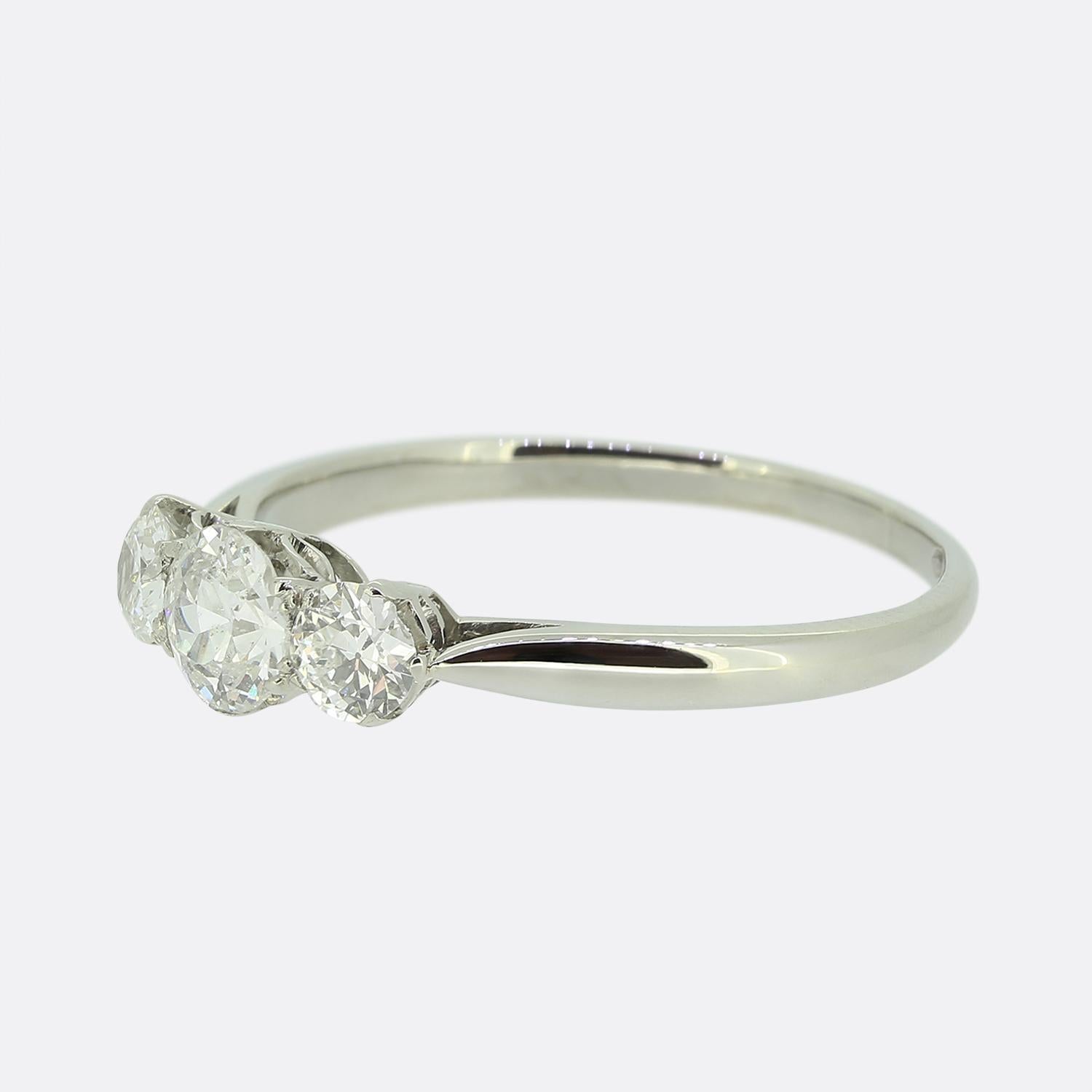 Here we have an 18ct white gold three-stone diamond ring featuring a trio of round faceted old cut diamonds. The centre stone (0.33ct) is set in a six pronged mount whilst being flanked on either side by a single slightly smaller stone (0.15ct).