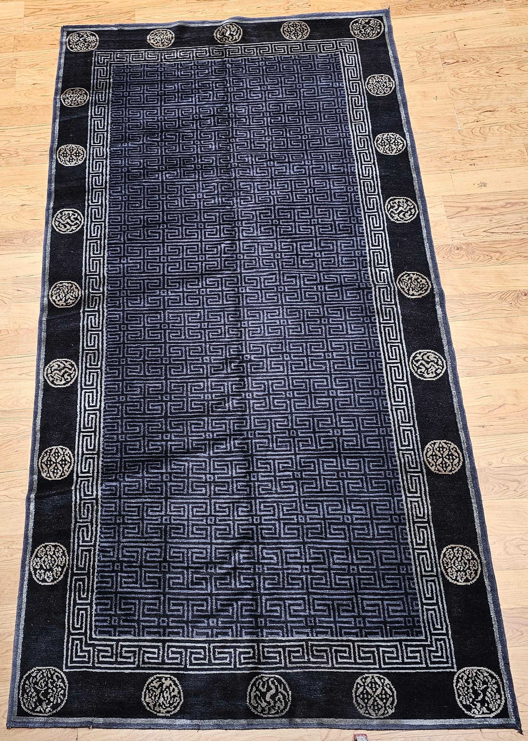 Discover the serene sophistication and spiritual depth of this captivating vintage Tibetan area rug. This exceptional piece features a refined lattice pattern rendered in elegant tones of black, lustrous gold, and subtle gray, embodying a profound