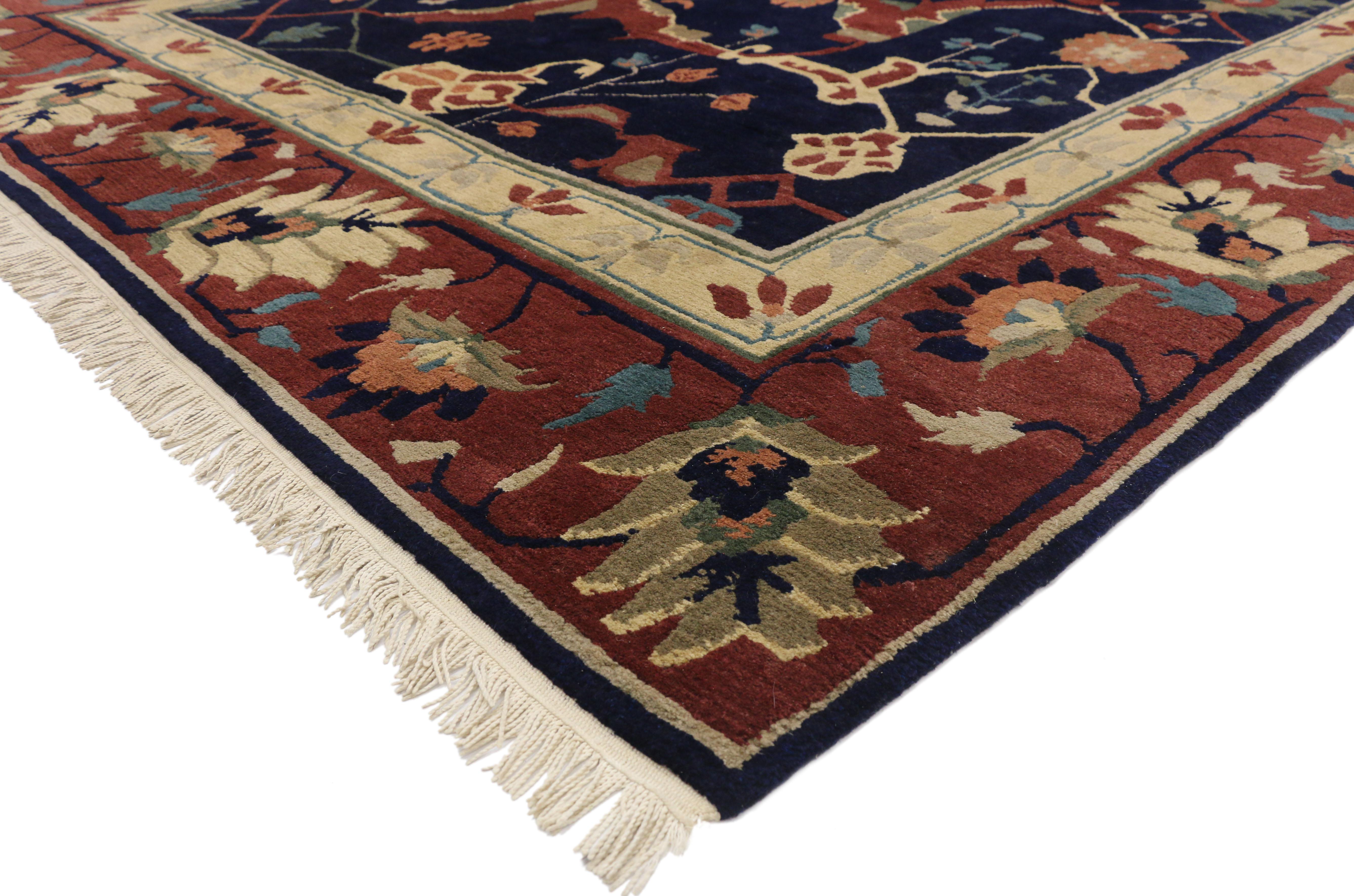 77262 Vintage Tibetan Area rug with Persian Serapi design. This hand knotted wool vintage Tibetan area rug beautifully displays a Persian Serapi all over design on an ink blue backdrop. The all over design are harder to come by than those with the