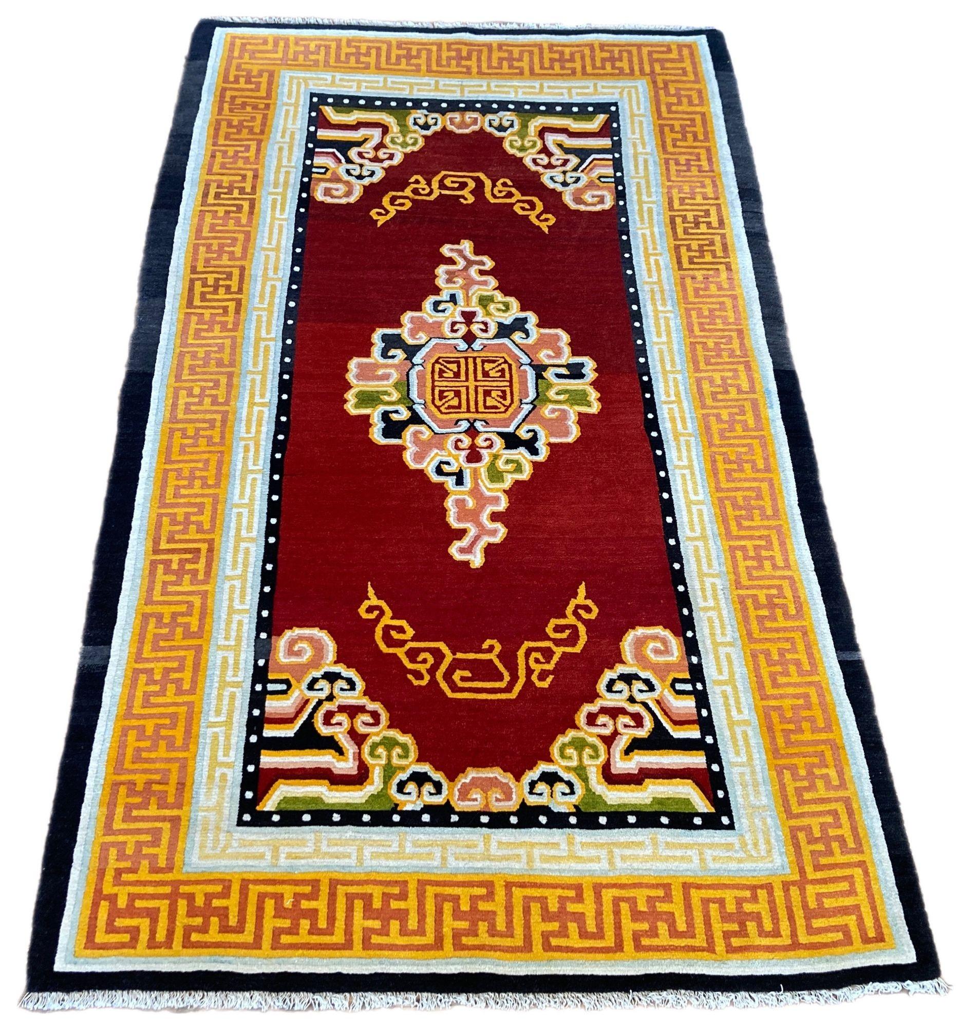 A fabulous 1930’s Tibetan rug with a simple cloudband design on an open red field surrounded by a red and gold key border. Lovely wool quality and great colours!
Size: 2.12m x 1.24m (7ft x 4ft 1in)
This rug is in good overall condition with very