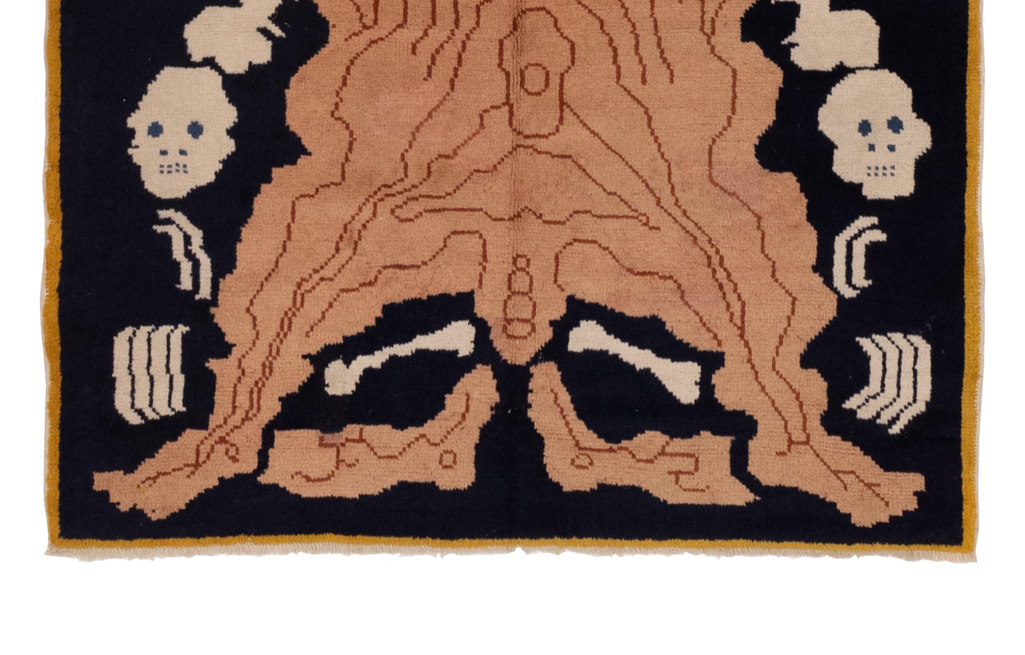 This vintage Tibetan rug dating back to the early 1900s, boasting a striking pictorial motif of a flayed man set against a rich black backdrop. Its remarkable design and timeless appeal render it a perfect adornment for any space. This stunning work