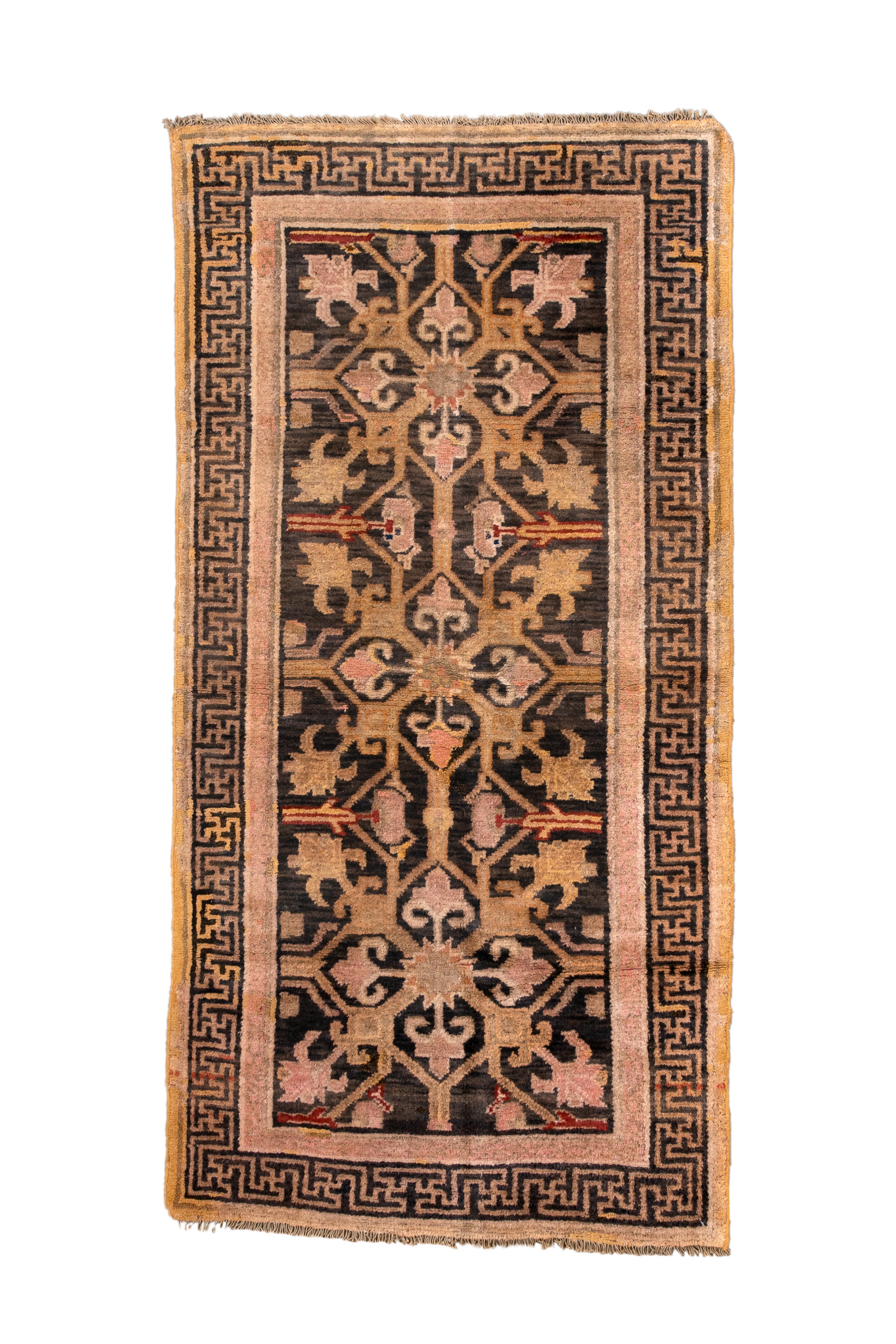This is a large-scale Tibetan interpretation of the Persian Herati design with three stacked, open diamonds enclosing palmettes and each radiating four additional palmettes, all on a darkest brown field. Main brown border with swastika frets, thick