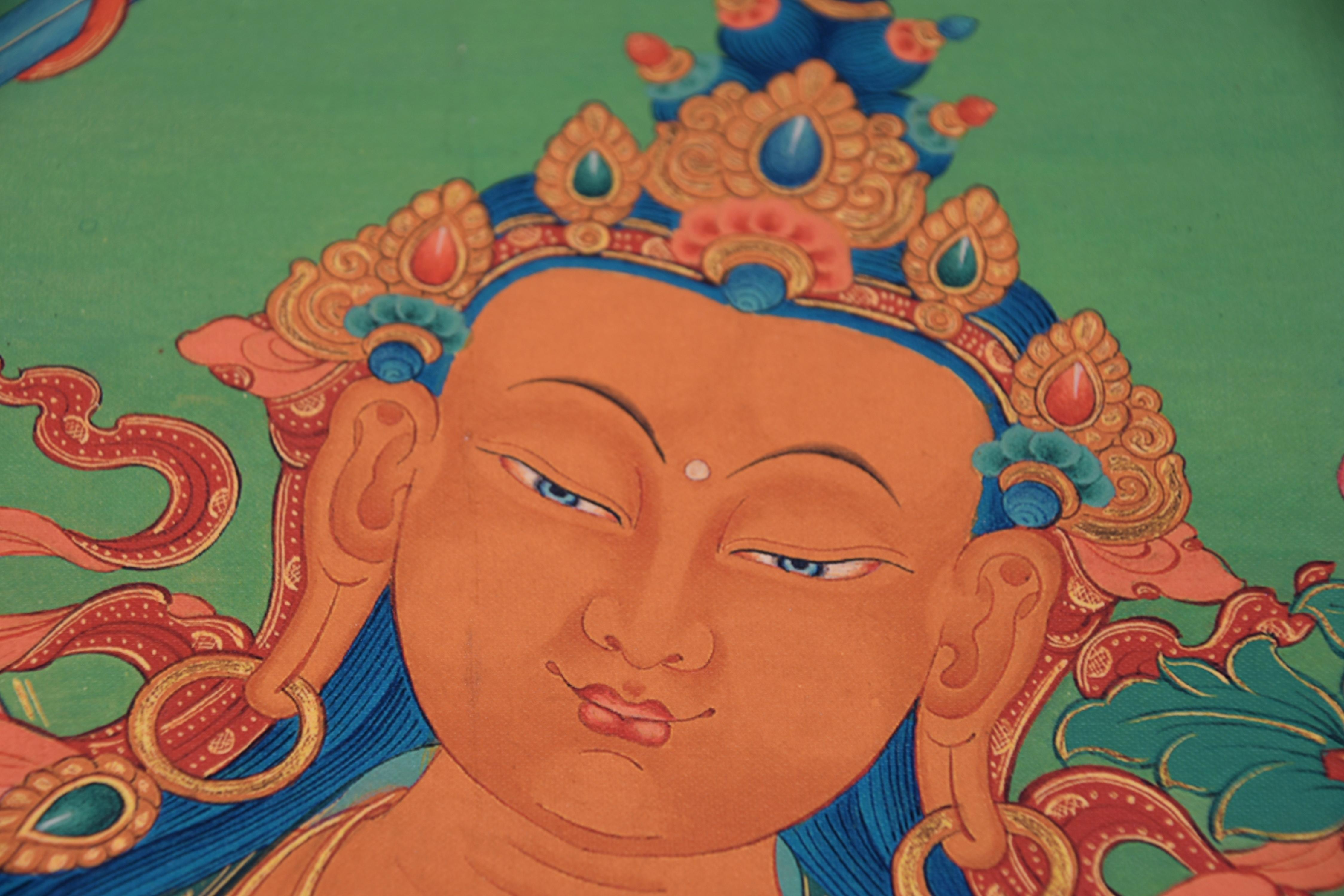 An one of a kind Thangka depicting the mighty Tibetan Manjushree, God of Divine Wisdom. Seated dhyana asana, rising above lapis blue sea, the full face with large downcast eyes under willow-leaf eyebrows flanked by pendulous earlobes adorned with