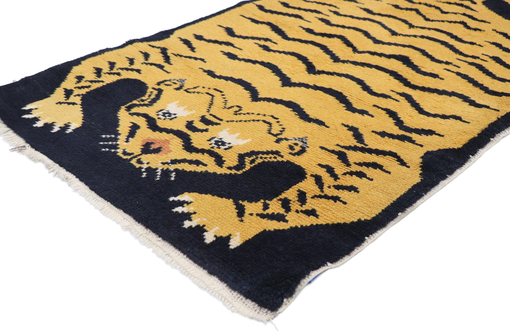78075 Vintage Tibetan Tiger rug 02'08 x 04'10. Be fiercely stylish with this hand-knotted wool vintage Tibetan tiger rug. The black field features a Tibetan tiger. The tiger is usually thought to symbolize strength and bravery. This depth of meaning