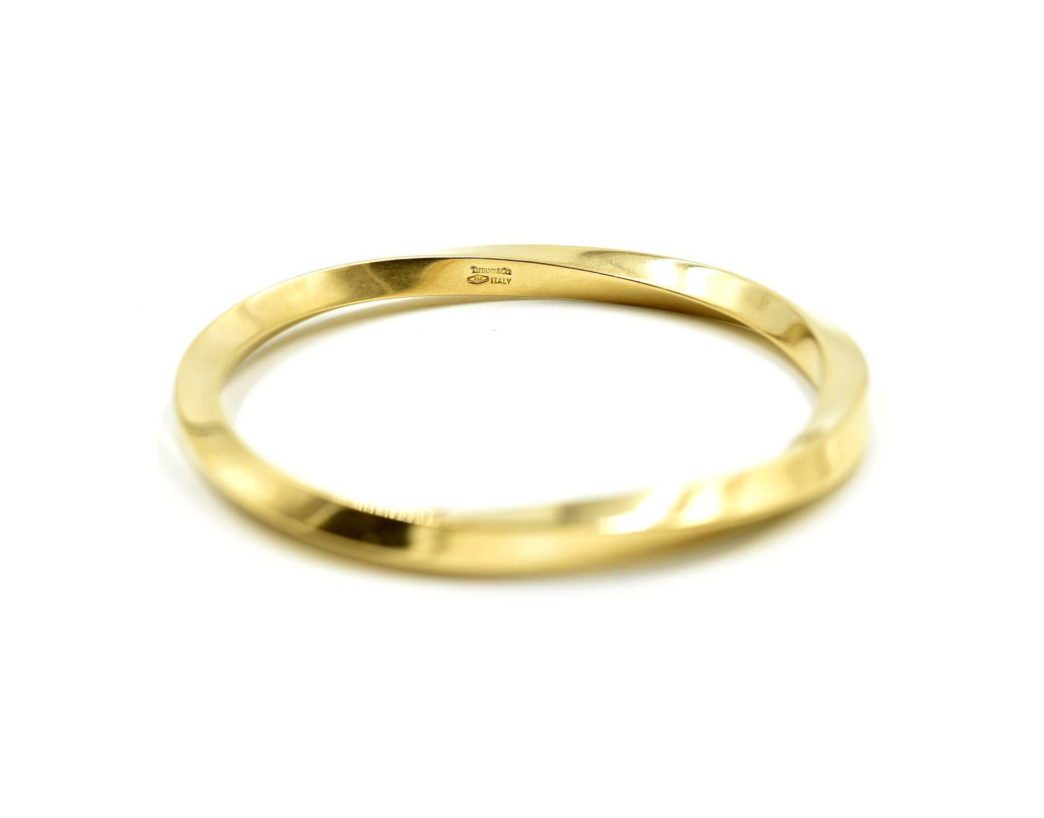 Designer: Tiffany & Co
Material: 14k yellow gold
Dimensions: the bangle will fit up to a 7 1/2-inch wrist and is 1/4 inches wide
Weight: 34.37 grams
