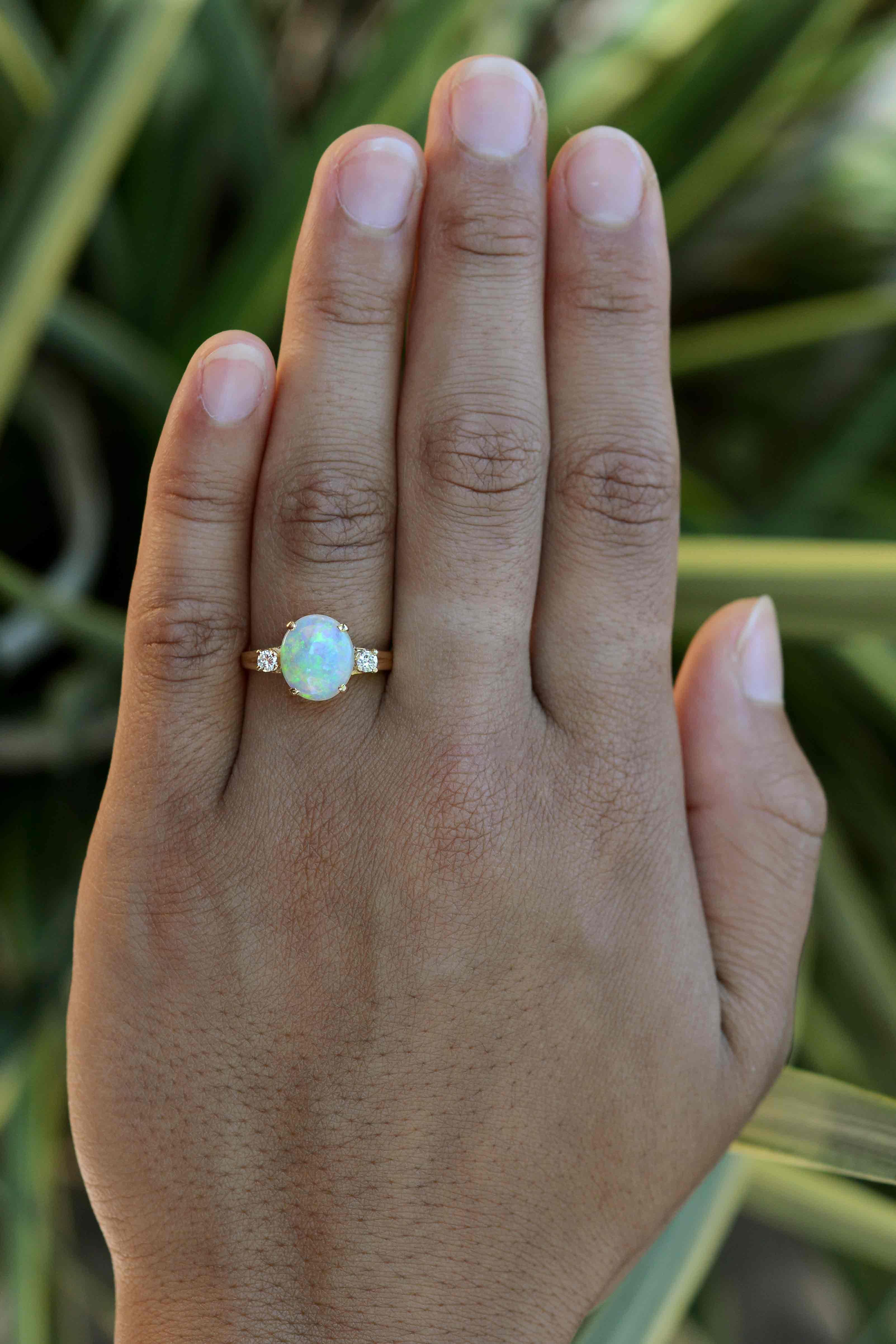 You'll enjoy this classic, vintage Tiffany 3 stone opal and diamond engagement ring for generations to come. The simple, Mid Century trinity or trilogy design can be worn as a bridal jewel, birthstone or statement ring. Centering on a kaleidoscopic