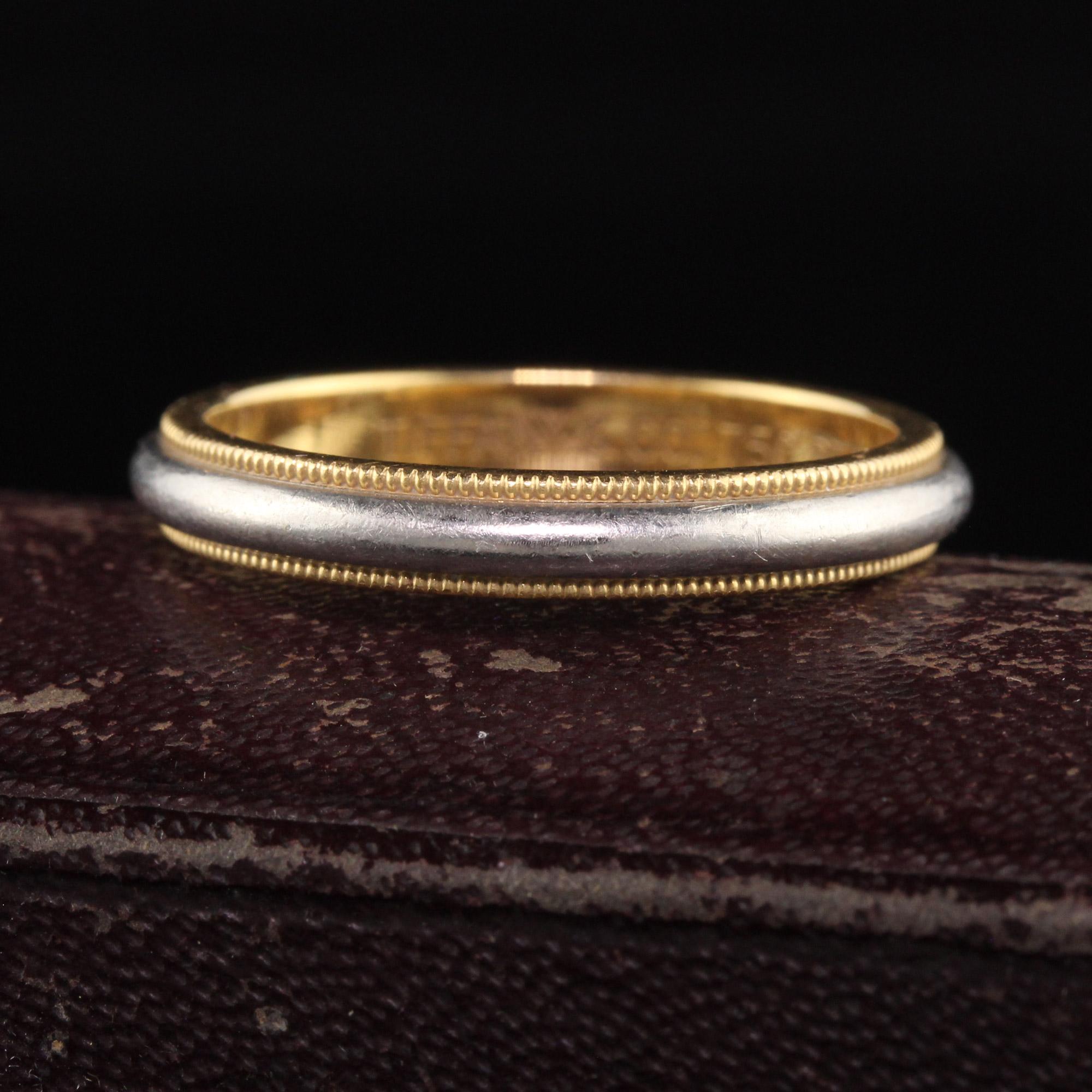Beautiful Vintage Tiffany and Co 18K Yellow Gold and Platinum Wedding Band. This classic wedding band is crafted in 18k yellow gold and platinum. This classic ring has milgraining around the entire ring and the inside of the band is engraved 