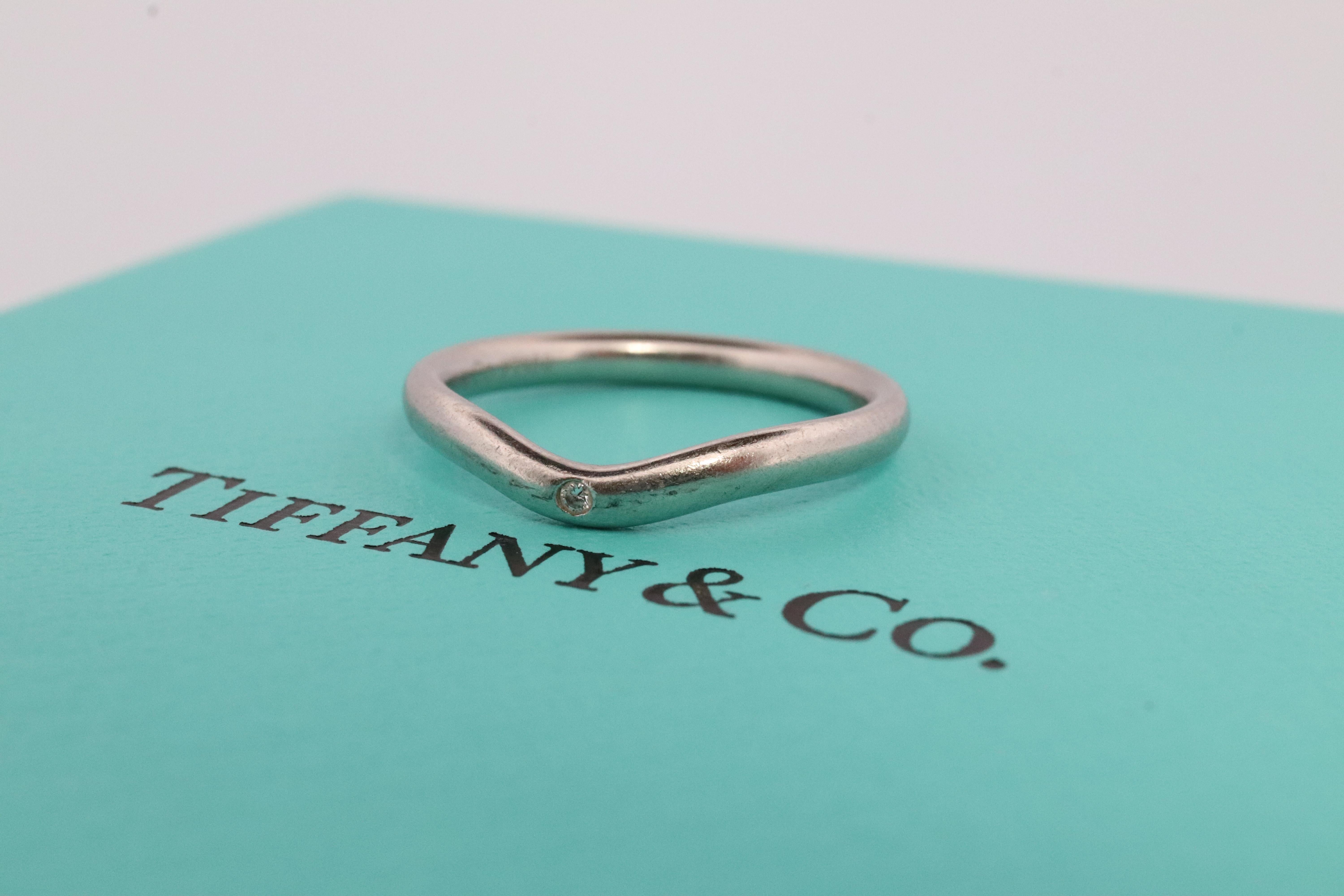 Rare Tiffany and Co. Platinum Curved Dainty ring

Single Diamond Bezel set into PT950.

Condition: Has not been polished. Has minimal scratching on the shank. Comes with original vintage Tiffany pouch. 

Details:

Size 5
2.5mm wide
3.7 grams
