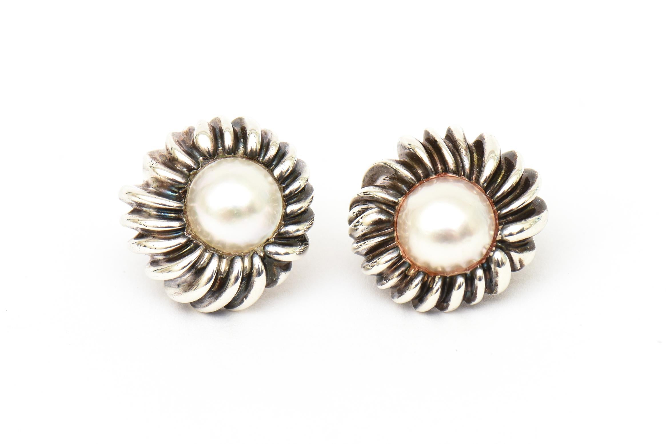 These classic and stunning vintage Tiffany and Co. hallmarked sterling silver and Mabe pearl lever back earrings can go day to evening. Hallmarked Tiffany &Co. Sterling. From the late 60's or early 70's. They have a perimeter sterling sculptural
