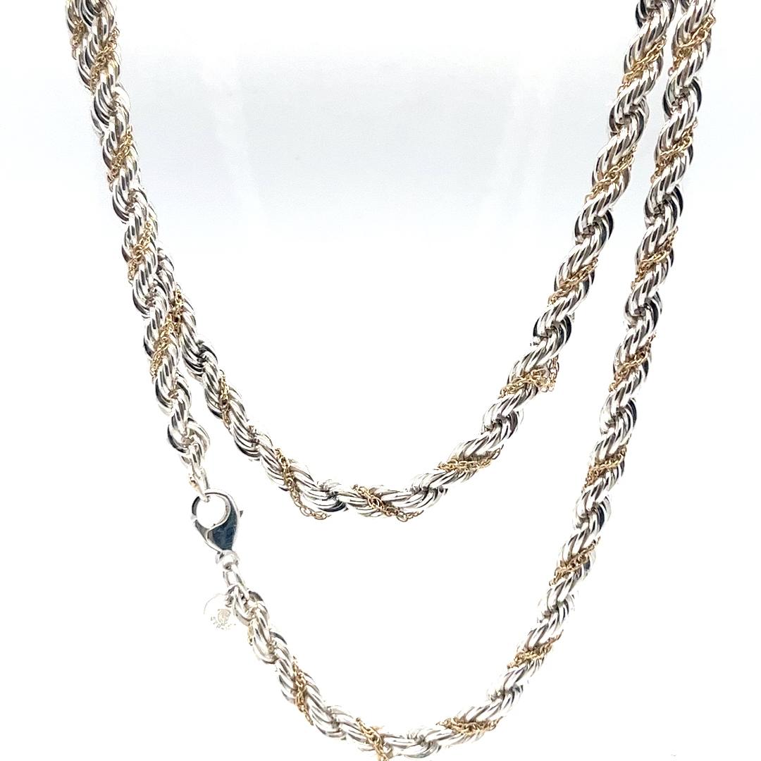 Tiffany and Co. sterling silver and 14 karat yellow gold 5mm rope chain necklace measuring 24 inches long with lobster clasp. $1875 MSRP. Includes Tiffany and Co travel pouch.