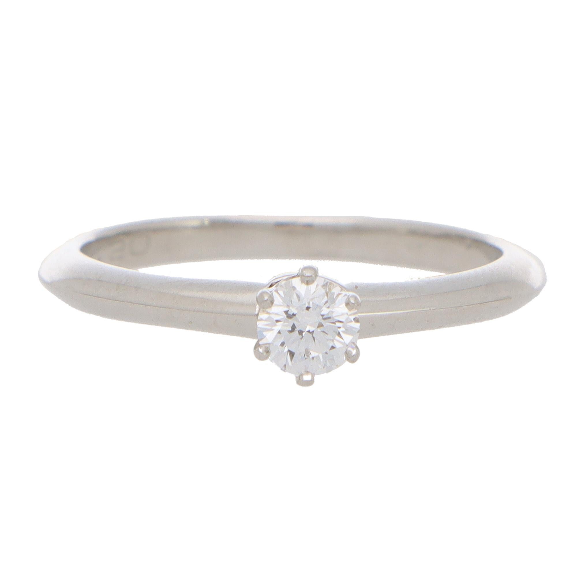 A beautiful vintage Tiffany & Co. round brilliant cut diamond single solitaire ring, set in platinum.

The piece is solely set with a beautiful 0.20 carat round brilliant cut diamond which is six-claw set in a knife edge band mounting.

The beauty