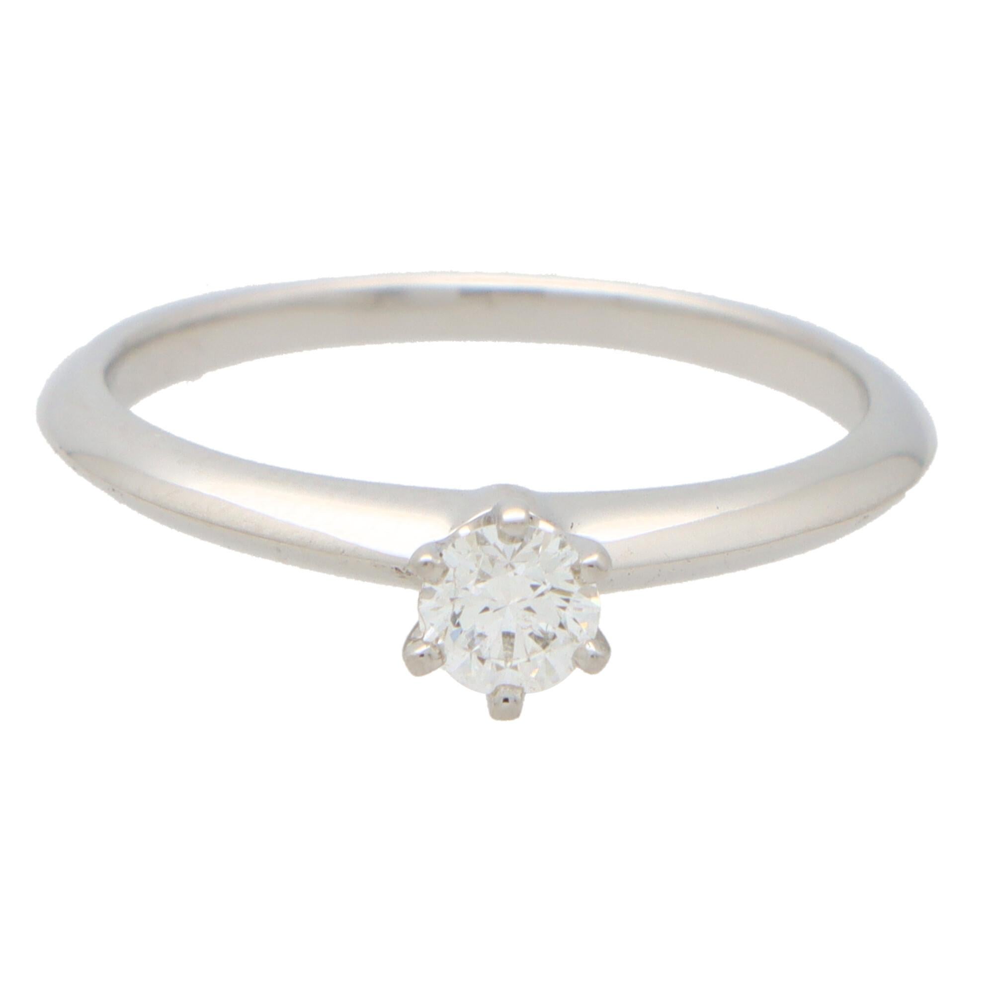  A beautiful vintage Tiffany & Co. round brilliant cut diamond single solitaire ring, set in platinum.

The piece is solely set with a beautiful 0.25 carat round brilliant cut diamond which is six-claw set in a knife edge band mounting.

The beauty