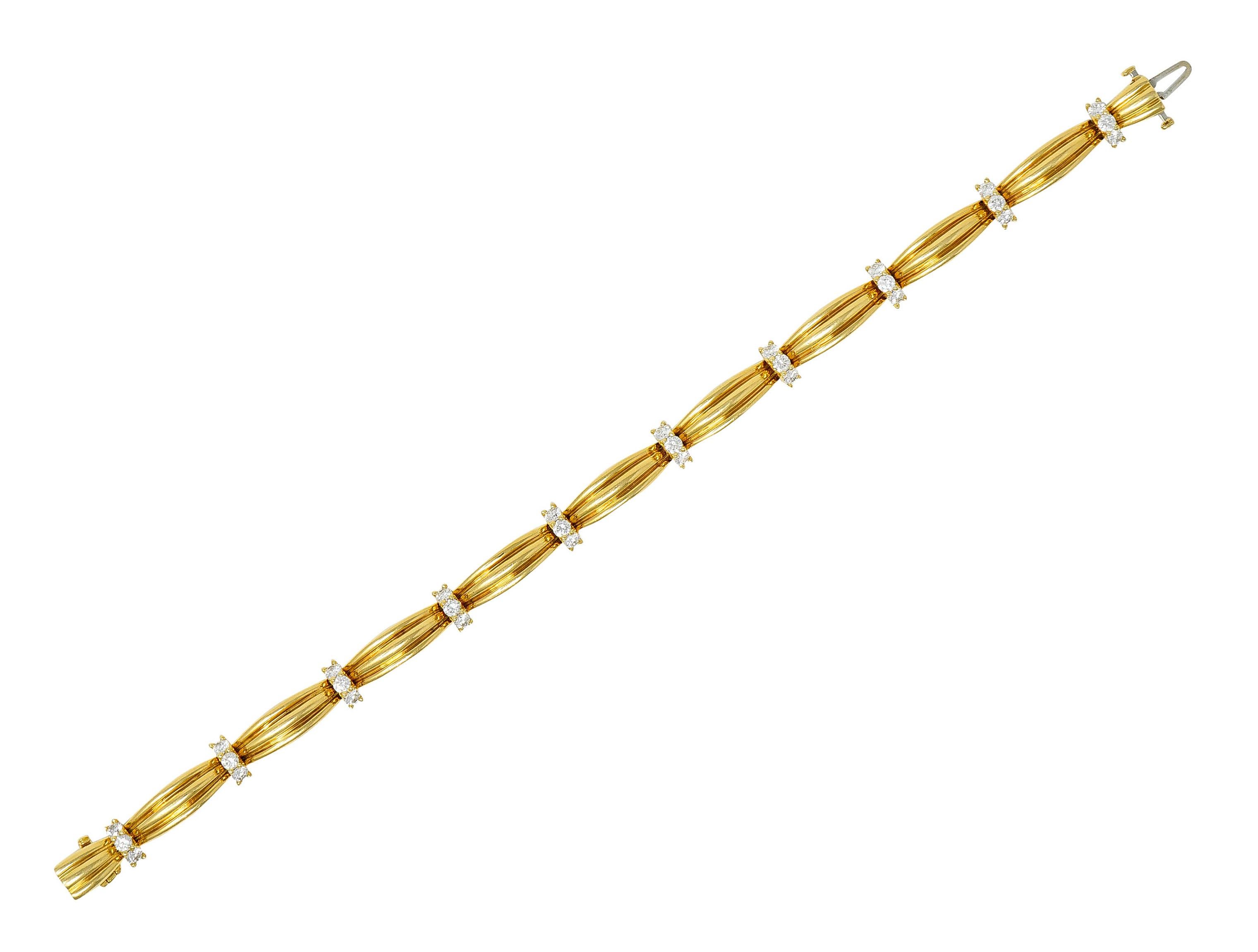 Bracelet is comprised of ribbed polished gold bar links

Alternating with diamond spacer links

Round brilliant cut diamonds weigh in total approximately 1.00 - F/G color with VS clarity

Completed by a concealed clasp with fold-over safety

Stamped