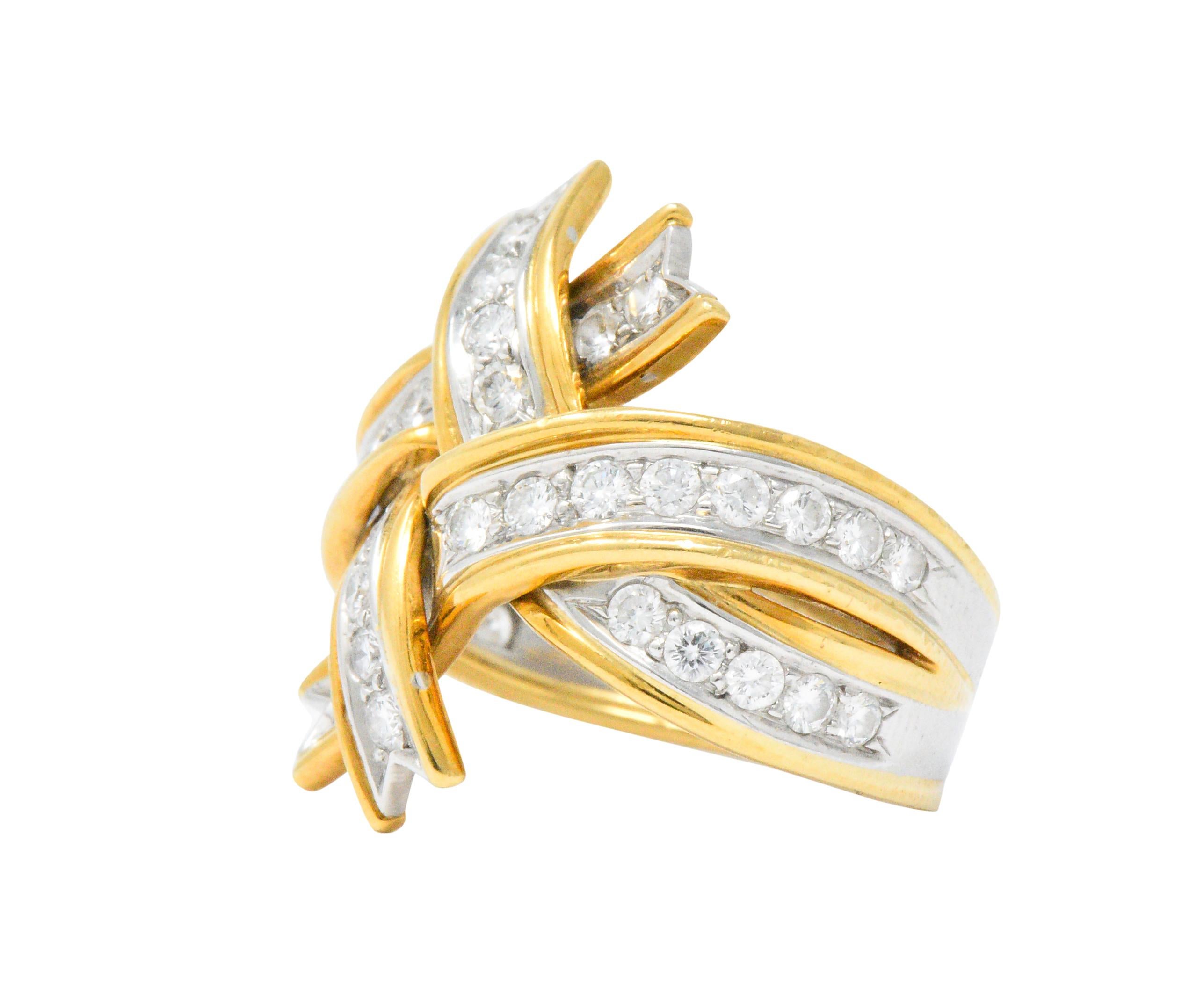 Intertwining and overlapping ribbons set with round brilliant cut diamonds, weighing approximately 1.14 carats, G/H color and VS clarity

Beautifully designed and detailed with appearance of flowing ribbons featuring dovetailed ends

Top measures