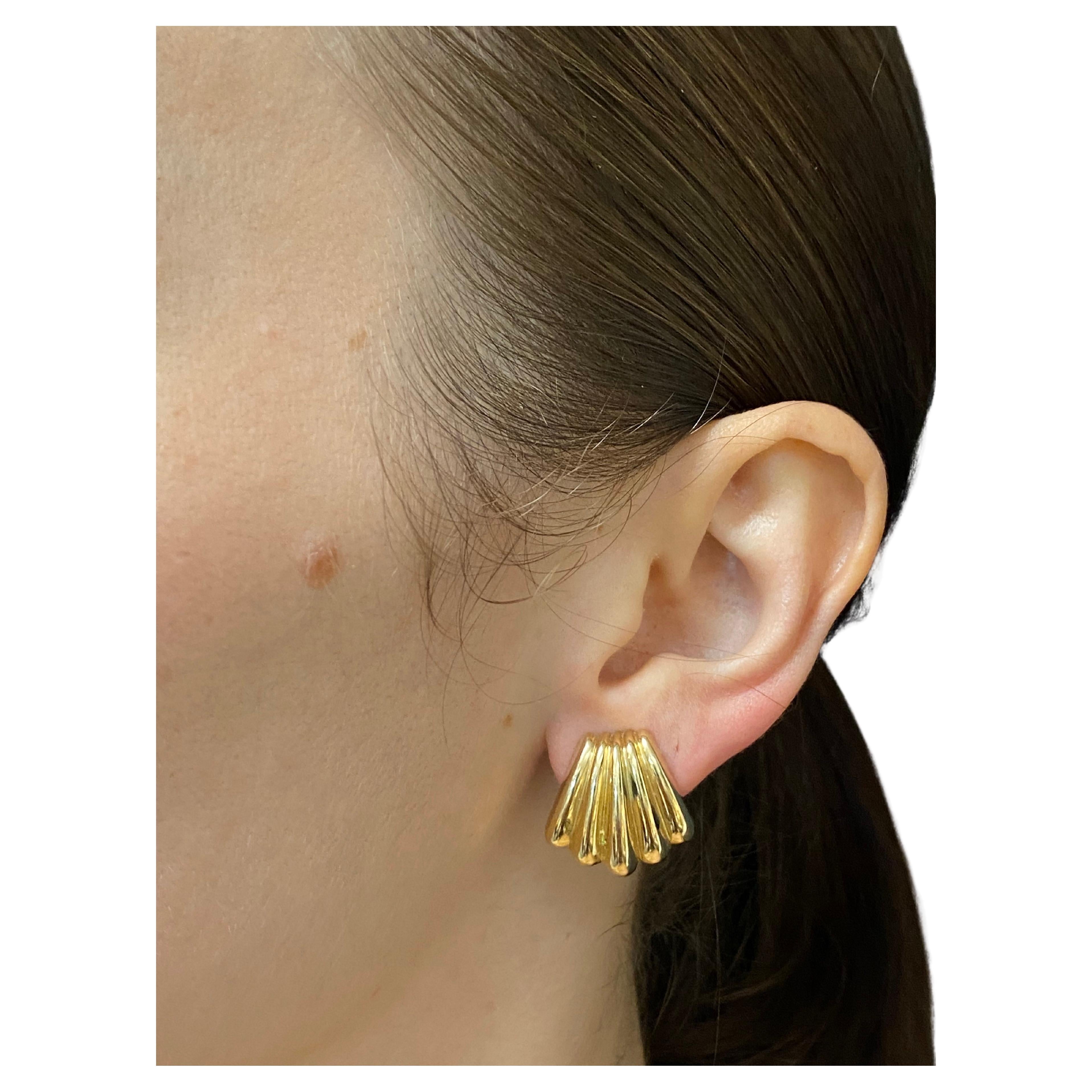 A pair of vintage Tiffany & Co. 14k gold earrings created in shell design. This beautiful everyday pair is made of glossy high polished gold. A great example of vintage jewelry where perfect craftsmanship is paired with excellent design. These silky