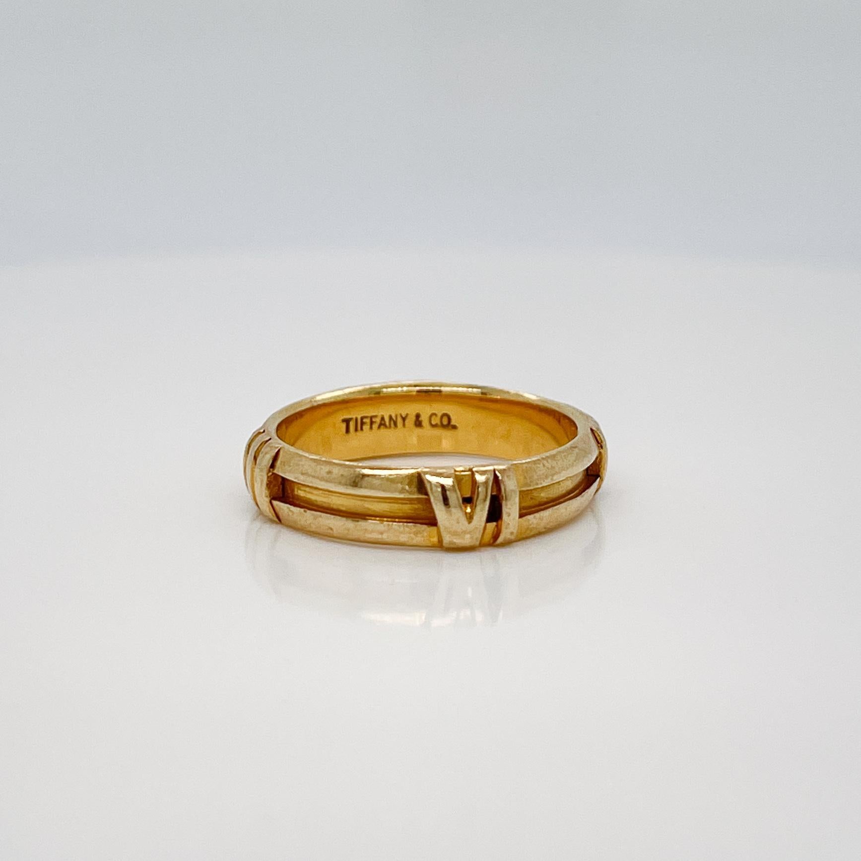 A very fine Atlas ring.

By Tiffany & Co.

In 18k yellow gold with raised Roman numerals around the ring's circumference.

The 'Atlas' collection was designed by John Loring in the 1980's and has come to be one of Tiffany's most successful