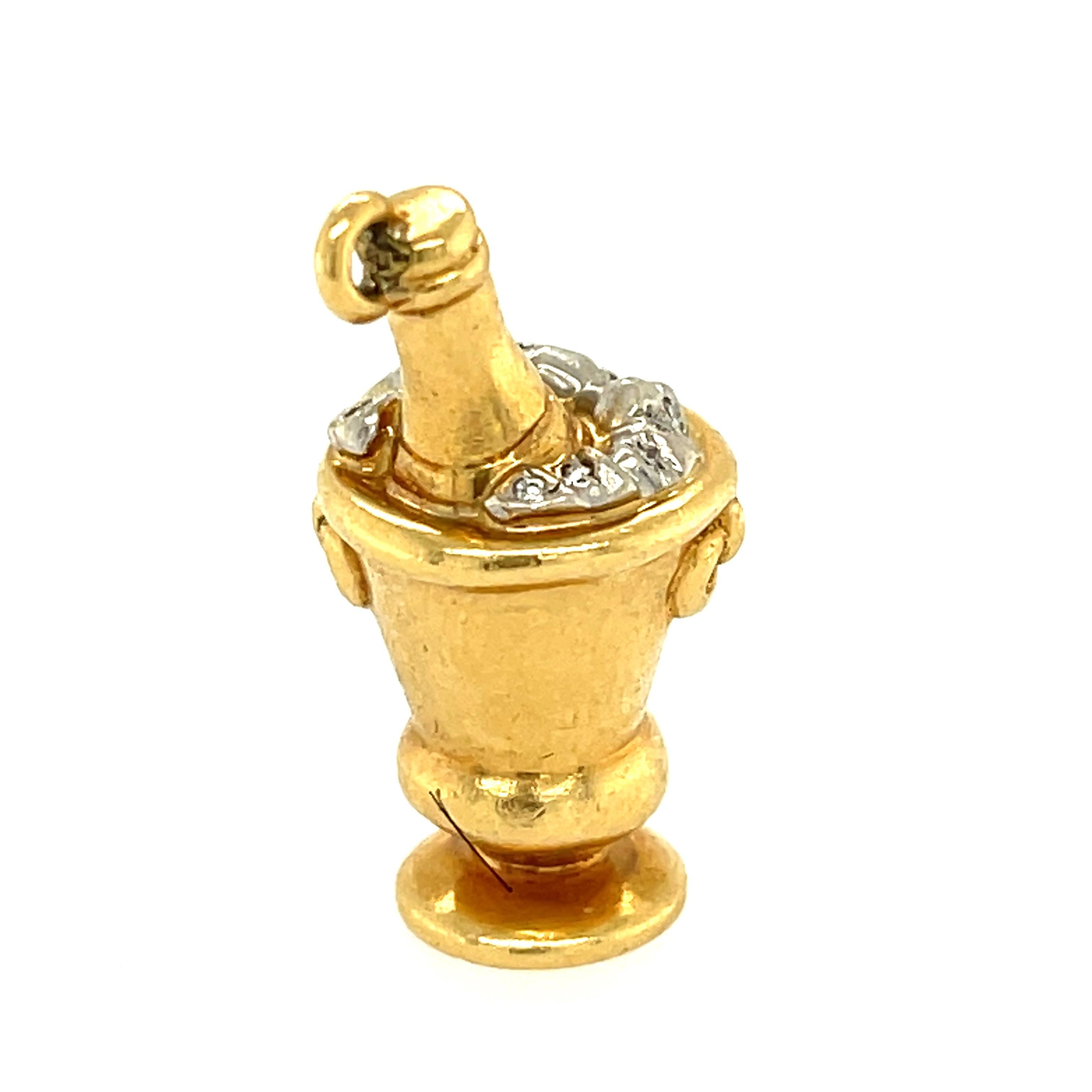 A vintage Tiffany charm in the shape of a champagne bucket with diamond ice cubes in the bucket made in 18k gold. The charm is wonderfully rendered and very festive. The charm was made around the 1990s. The charm 11 round brilliant diamonds weighing