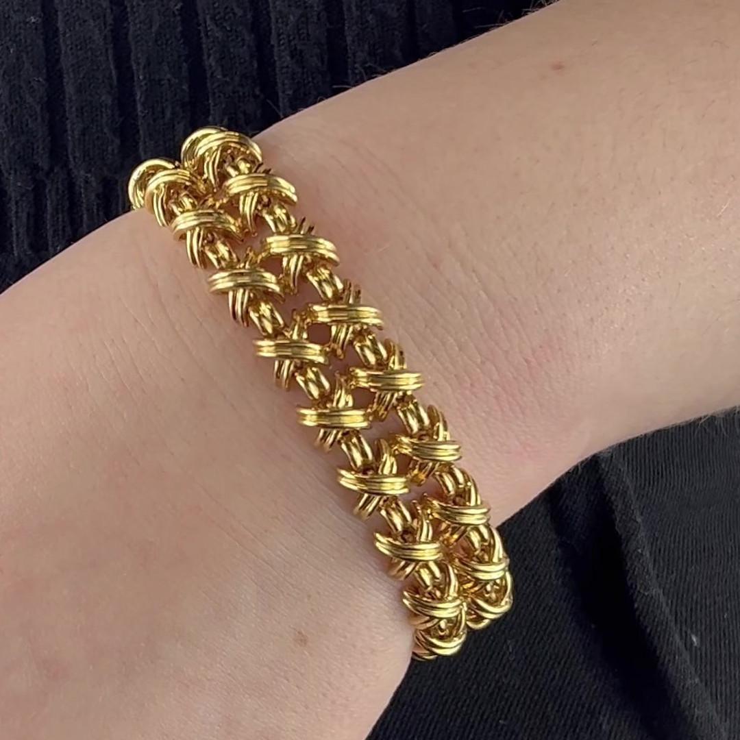 One Vintage Tiffany & Co 18 Karat Gold Signature X Double Bracelet. Crafted in 18 karat yellow gold, signed Tiffany & Co., with purity marks. Circa 1980s. The bracelet measures 7 inches in length and 1/2 inch in width. 

About this Item: Drape your