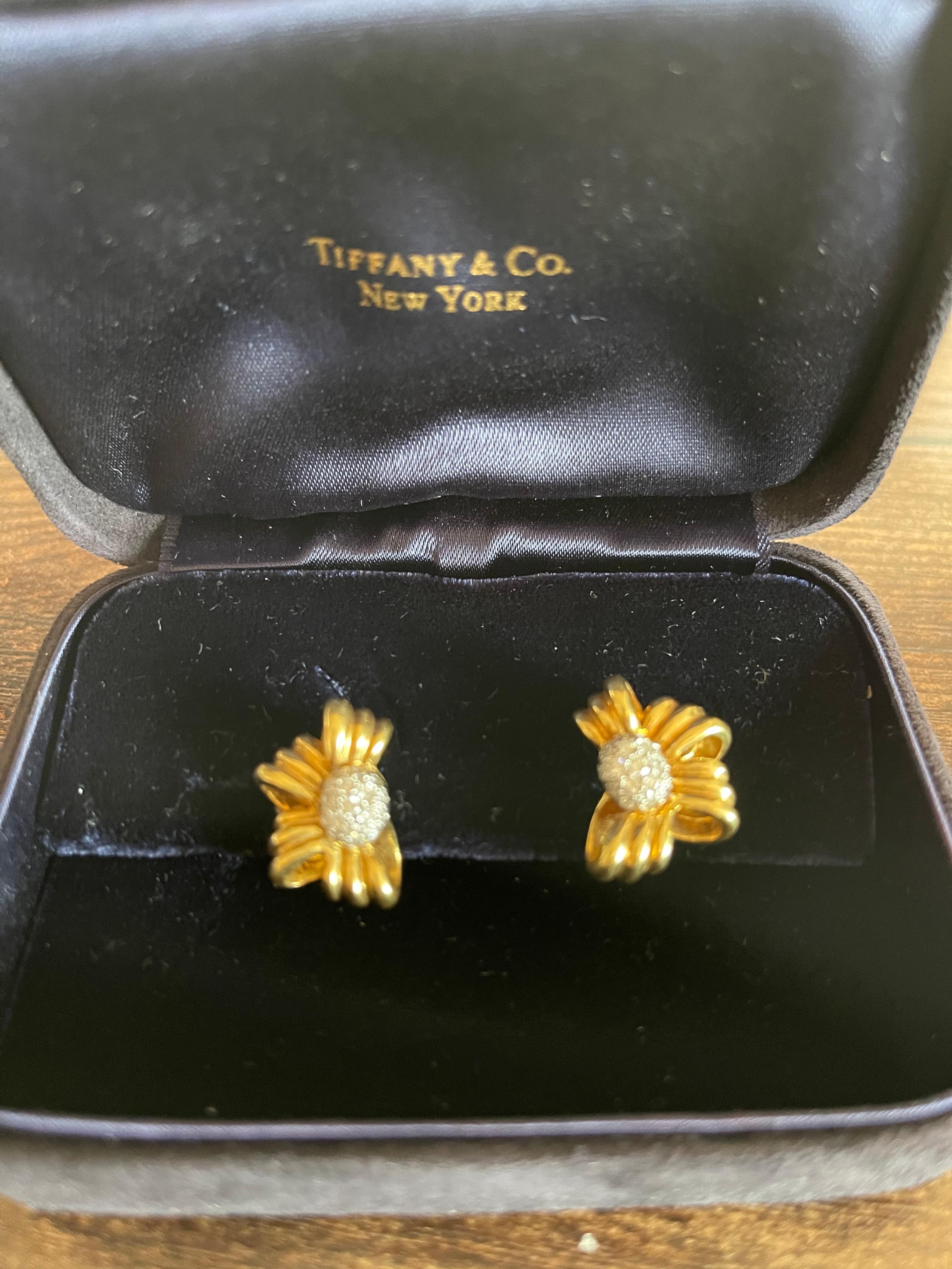 A pretty pair of vintage half bow earrings set with a diamond center by Tiffany & Co. Circa 1980. The center of the earring is pave set with 36 round brilliant diamonds weighing approximately 0.40 carats total. The earrings sit nicely on the ear,