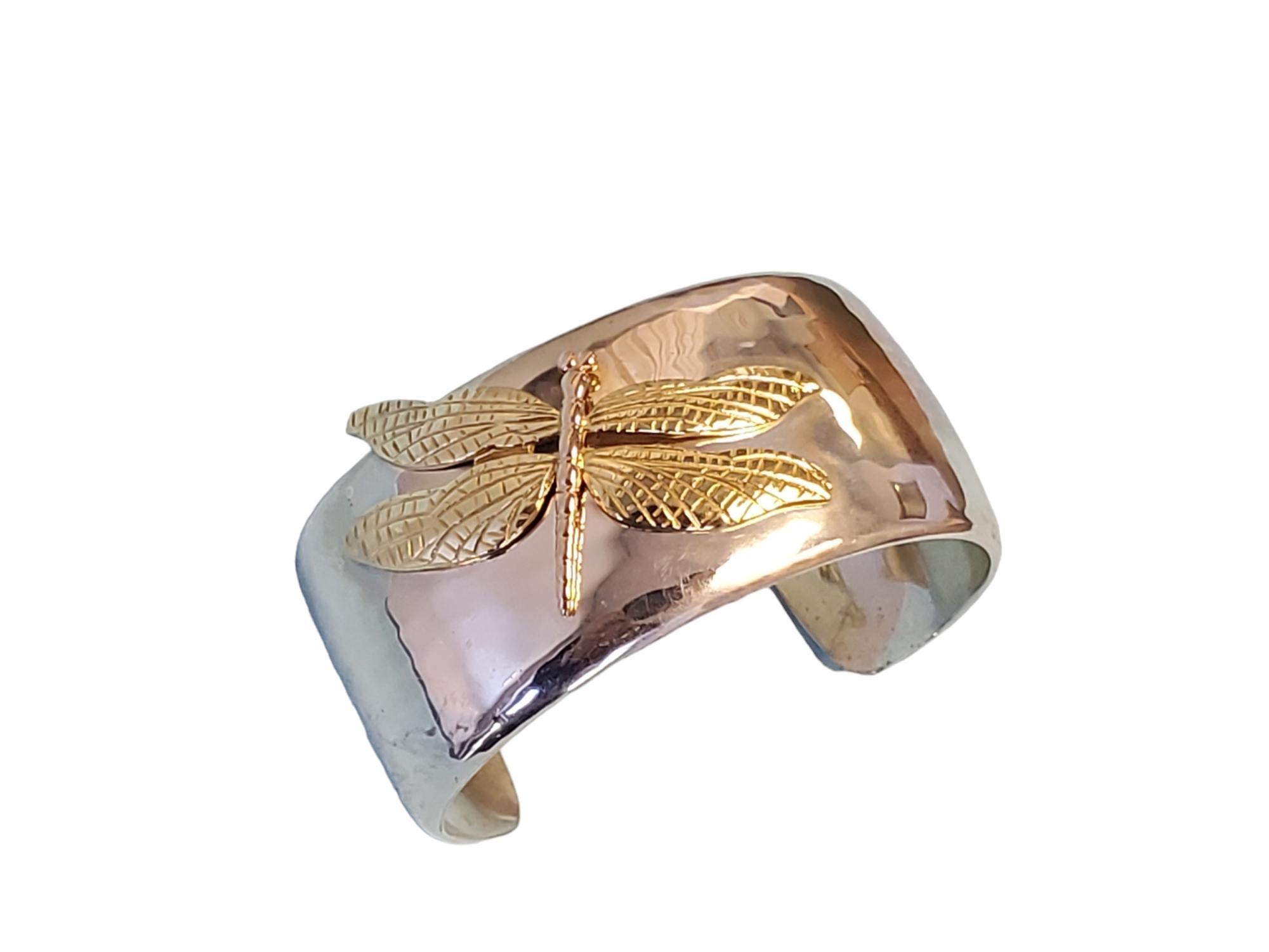 Vintage Tiffany & Co. Dragonfly Cuff Bracelet

Listed is a fantastic vintage Tiffany & Co. sterling and 18k tri-color cuff. This is a wide and wonderfully made cuff by Tiffany & Co.  The dragonfly done in 18k yellow and rose gold is the star of this