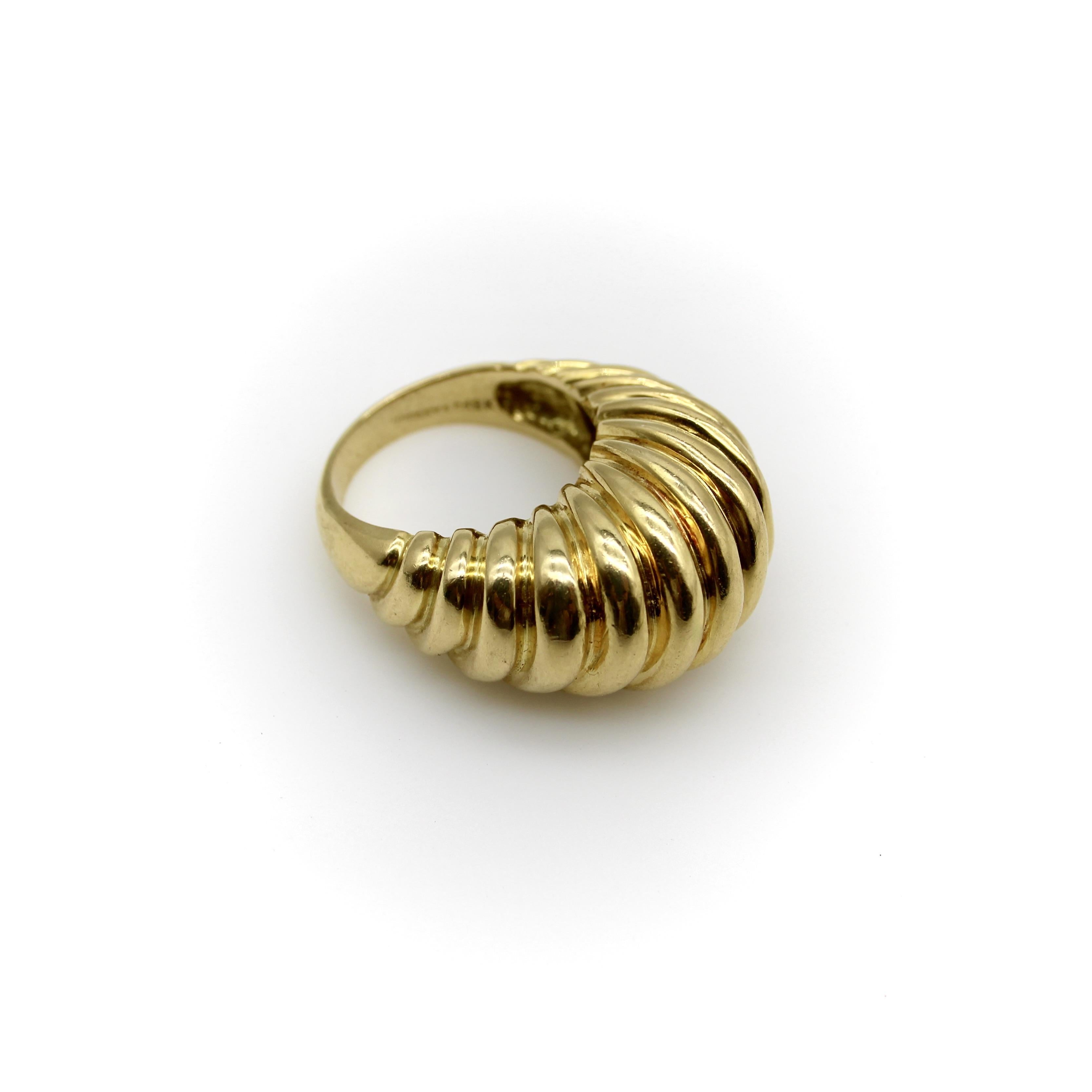 A classic 18k gold fluted dome ring by Tiffany & Co., circa the 1970’s. An eye catching piece with substantial presence on the hand, the ring has a beautiful high domed profile with rhythmic fluting that is diagonally angled for a wavelike action