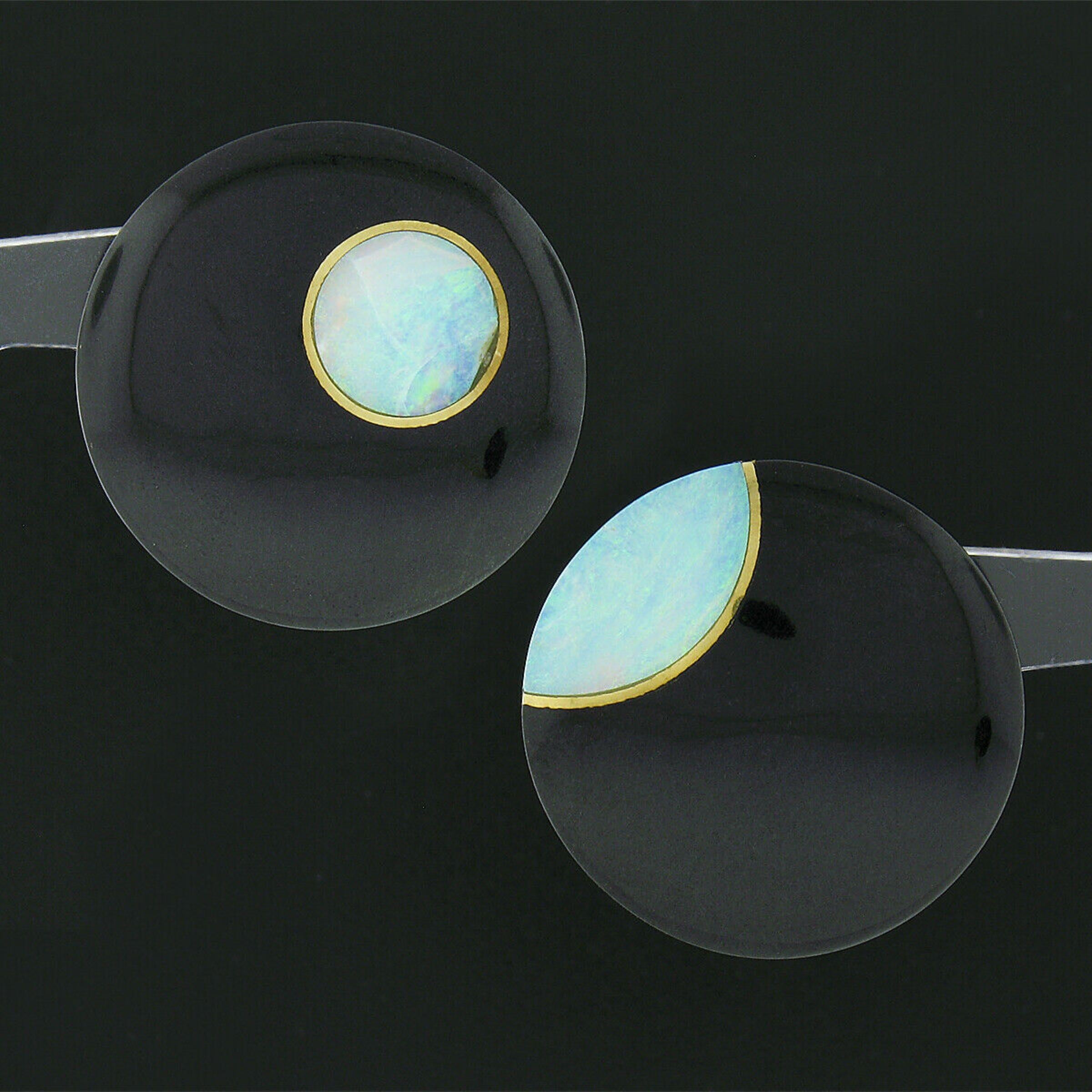 Here we have a vintage pair of Tiffany & Co. earrings that were crafted from solid 18k yellow gold with each featuring a large black onyx that is neatly set with a fine opal. The beautiful round cabochon cut onyx are substantial in size and are