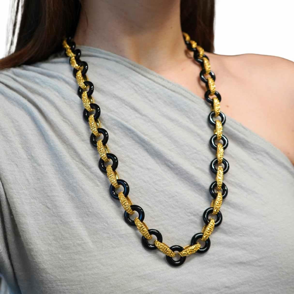 This Tiffany & Co. onyx and 18k gold necklace reflects the bold, sculptural aesthetic the house favored in the late 1970s through the mid-1980s. Alternating polished black onyx links and textured 18k gold connectors create a striking rhythm, while