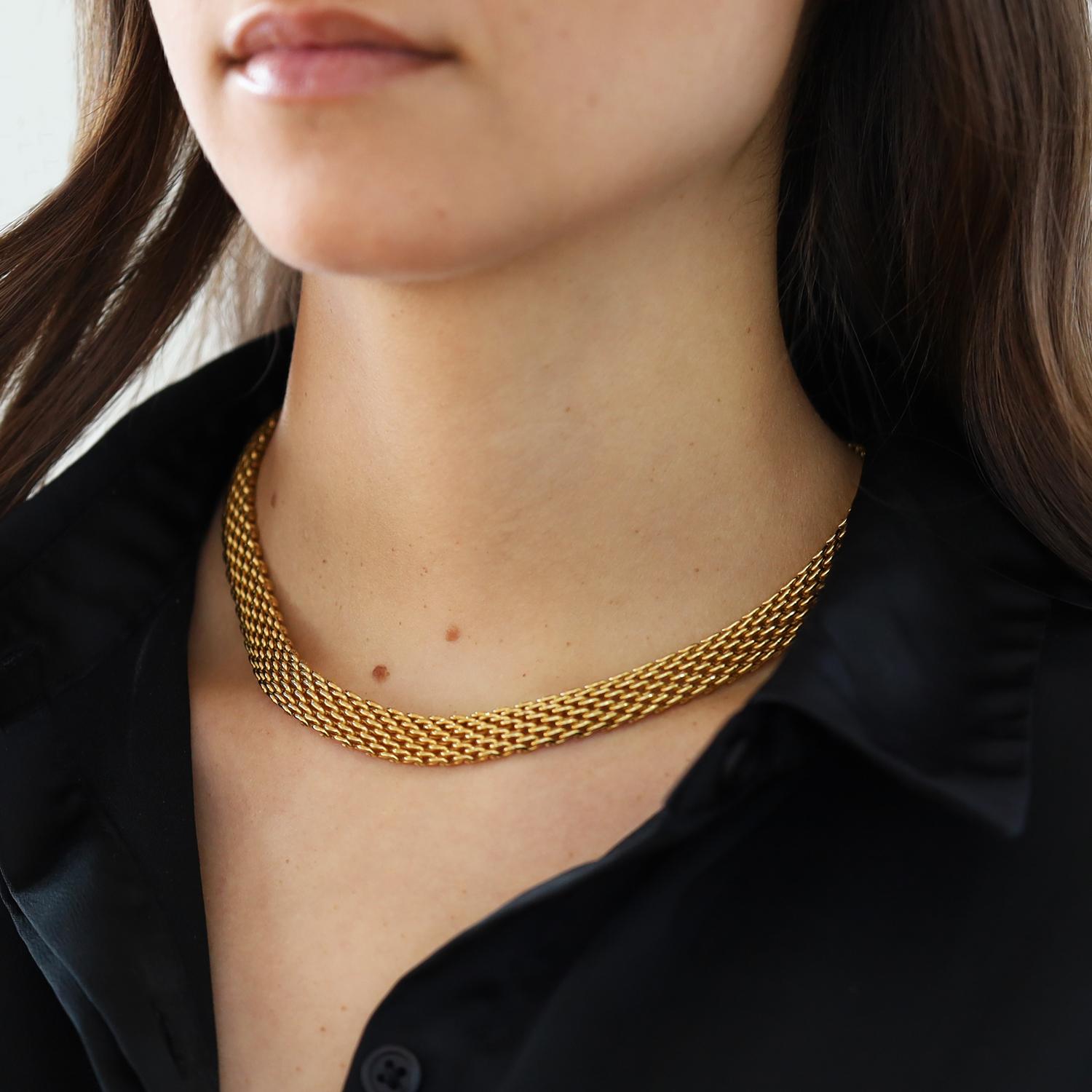 A distinctive vintage 18k yellow gold Tiffany & Company necklace. This circa 1990s statement piece sits elegantly as a collar and drapes just right on your neck. The supple, wide mesh feels luxurious when worn and is perfect for everyday attire or