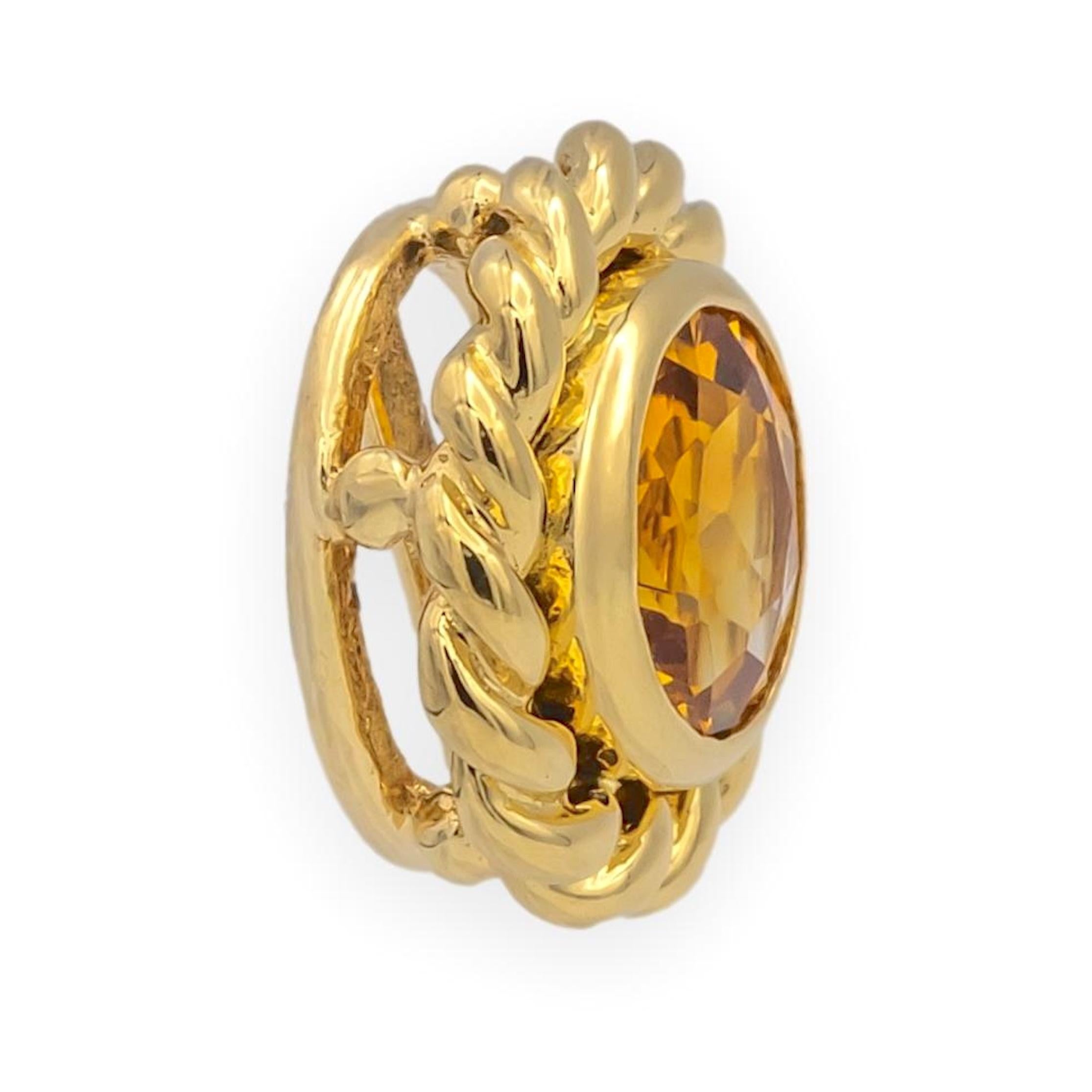 Vintage Tiffany 
Co. pendant crafted in 18K yellow gold, showcasing a richly colored Madeira citrine of deep golden-orange tone with fiery red undertones. The round faceted citrine is bezel-set within a twisted rope border, giving the piece